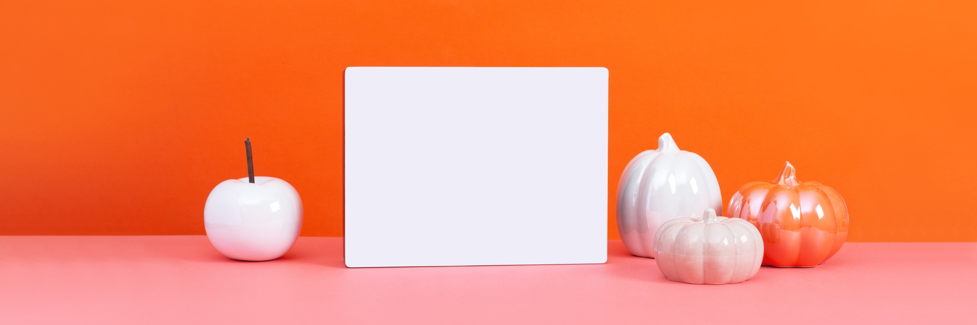 Lightbox with text Happy Thanksgiving with ceramic pumpkins on table, vivid color background.