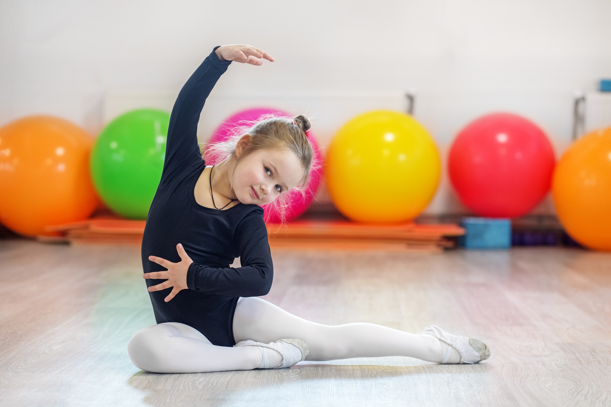 Little girl dancing in training. The concept of sports, education, hobbies, training and dance.