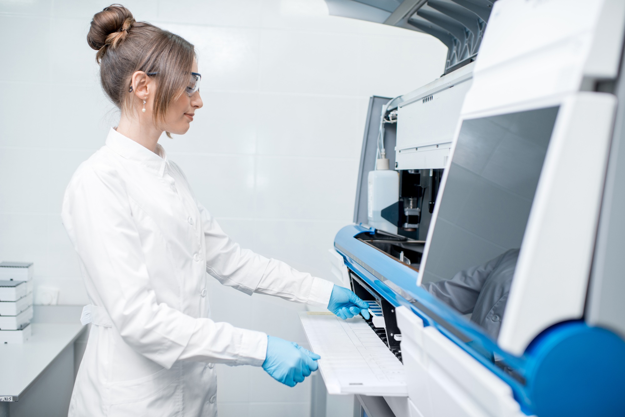 Medical technician working with analyzer