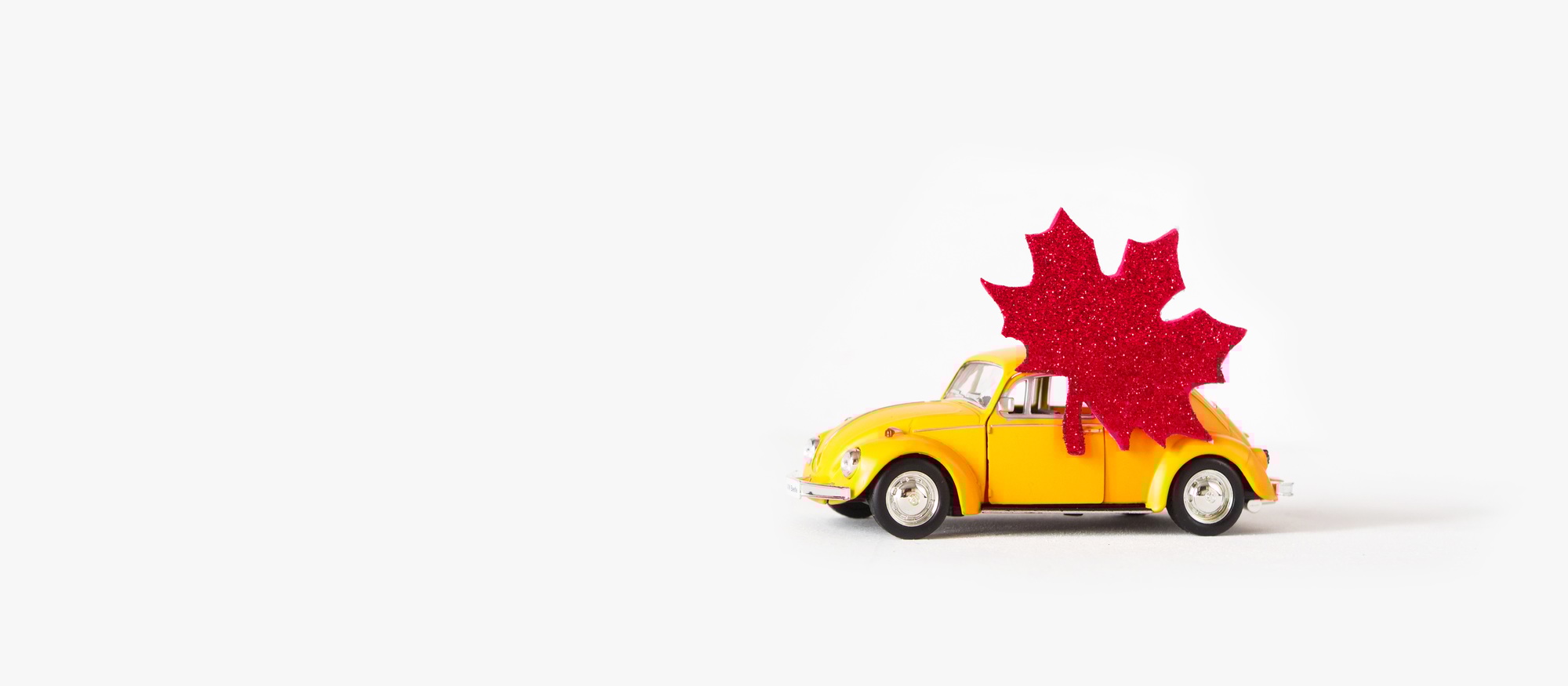 Minsk, Belarus-June 2020: Happy Canada Day, yellow retro car with the flag and Canada maple leaf