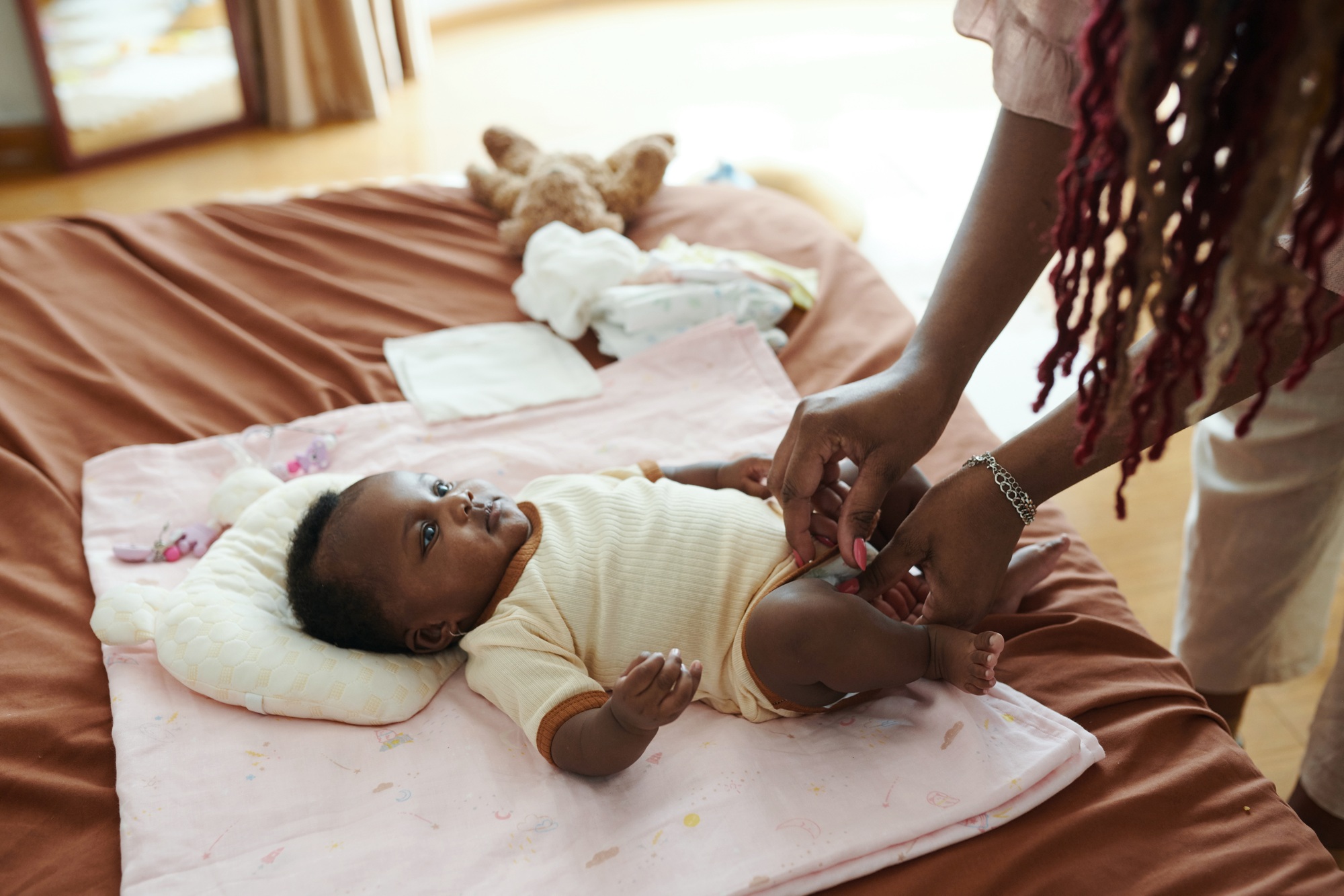 Mother Changing Diaper of Baby