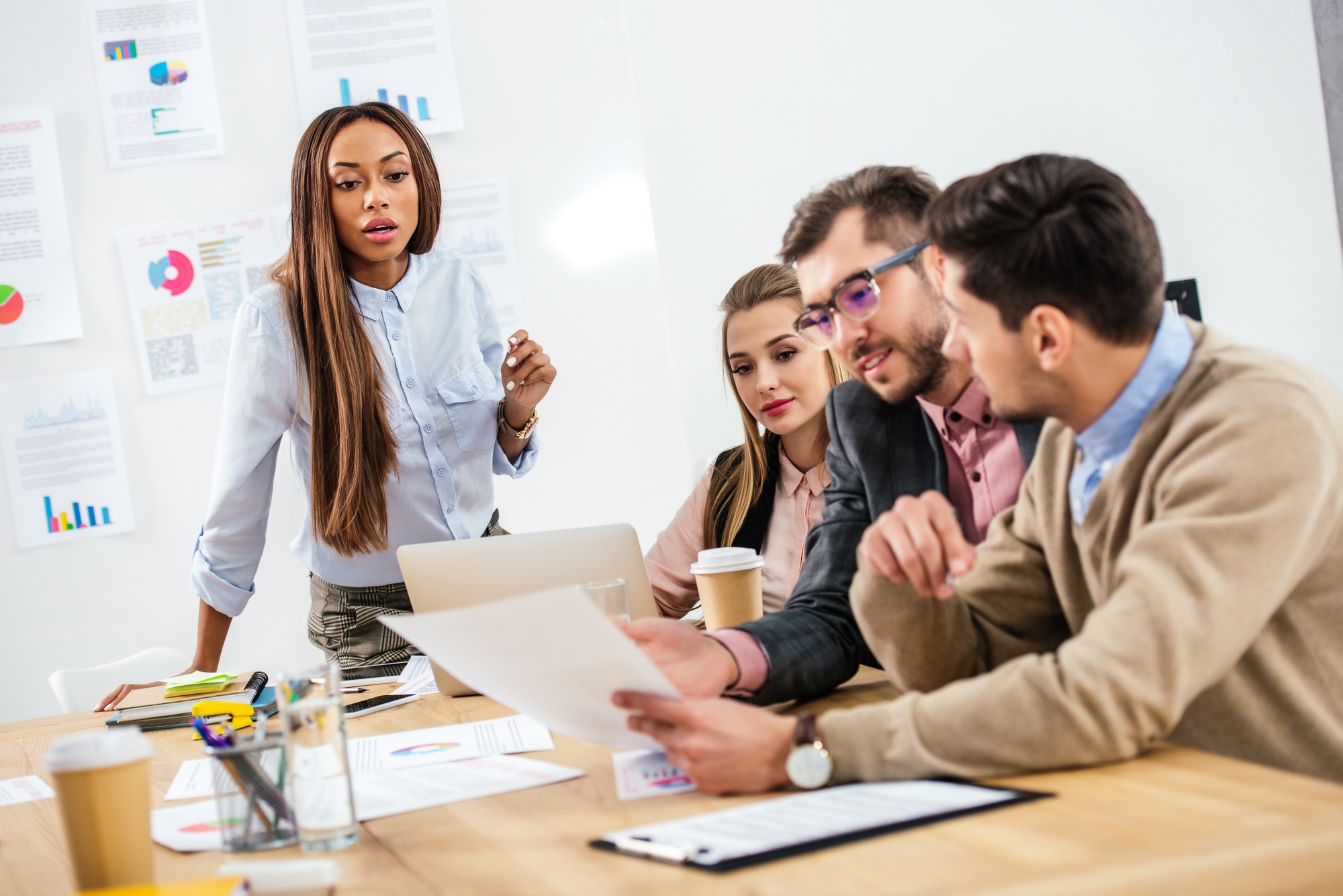 multicultural group of marketing managers working on project together in office