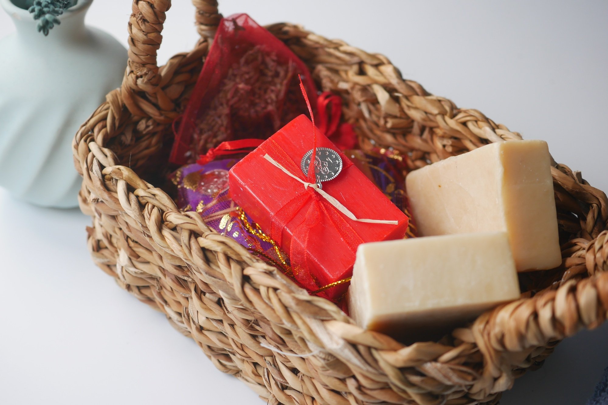 Natural soaps and gifts arranged in a woven basket
