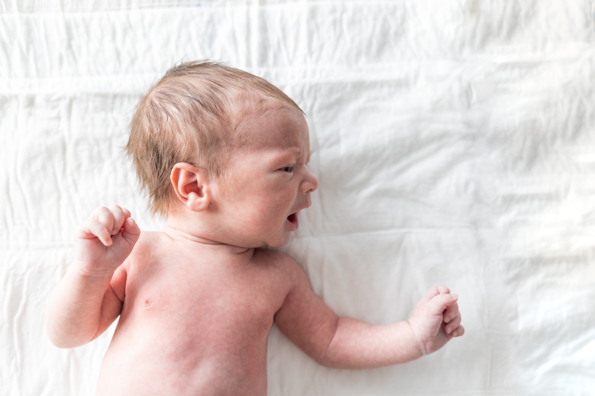 Newborn baby laying on changing table