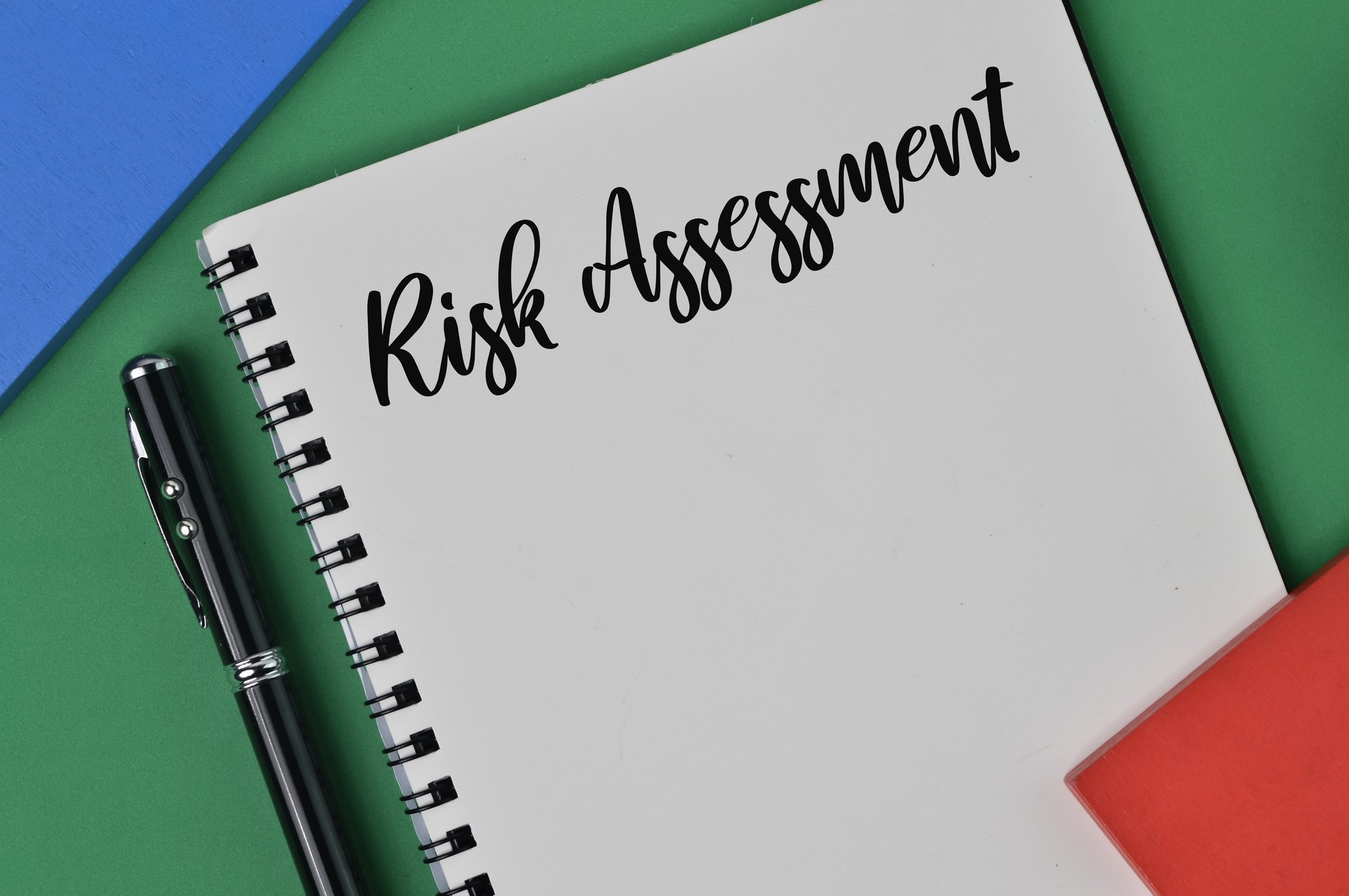 Notebook written with text RISK ASSESSMENT. Business concept.
