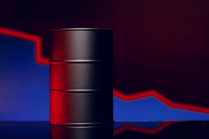 Oil prices fall concept. Oil barrel against decline chart