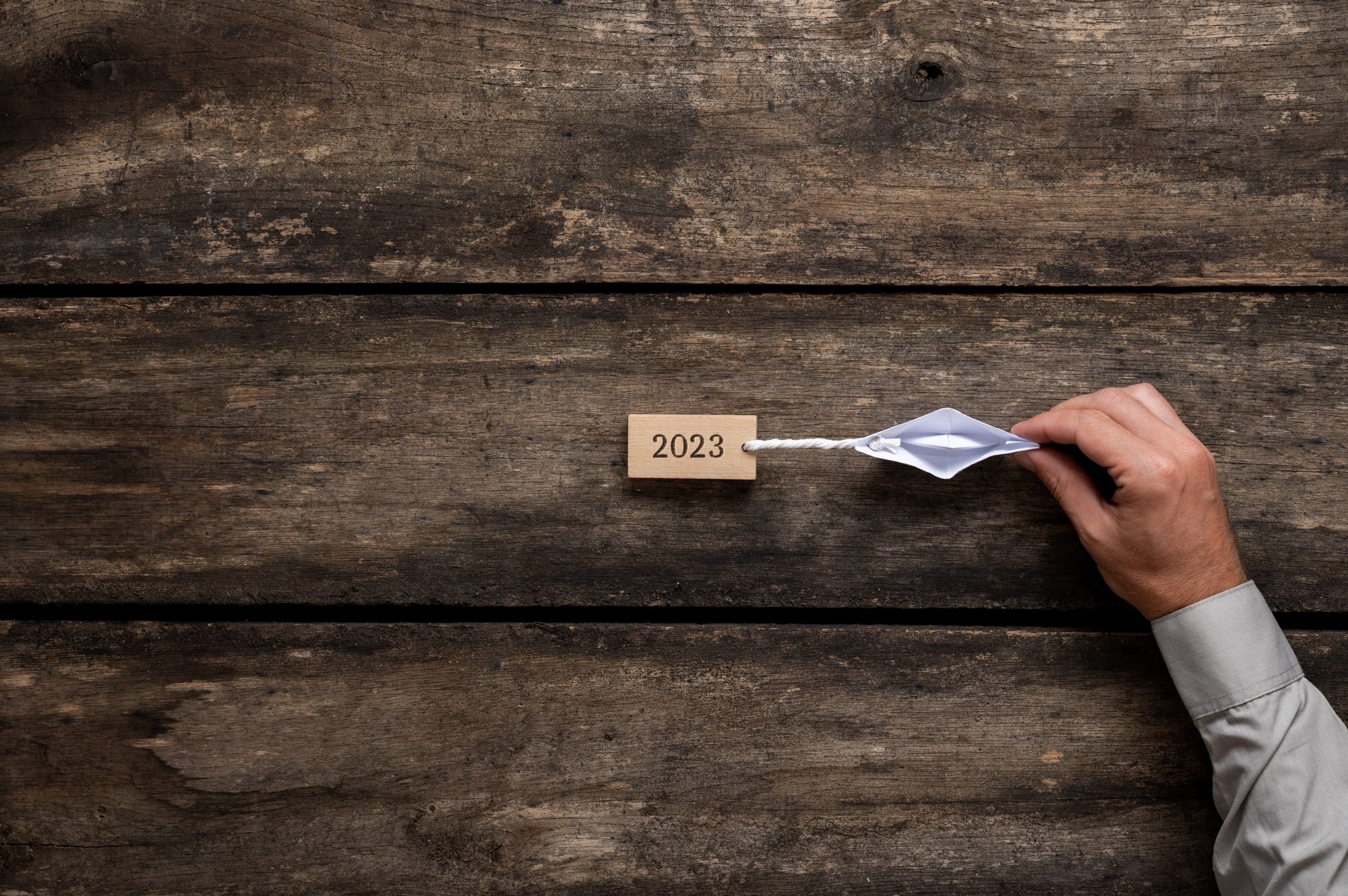 Origami boat dragging a 2023 sign