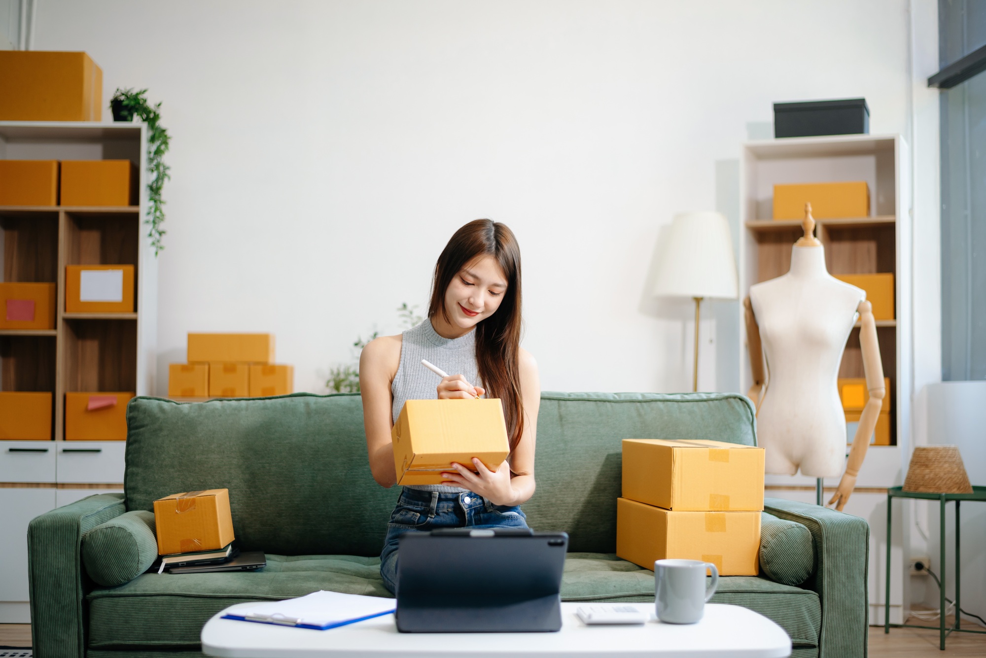 oung woman managing online sales and shipping from a modern home office.