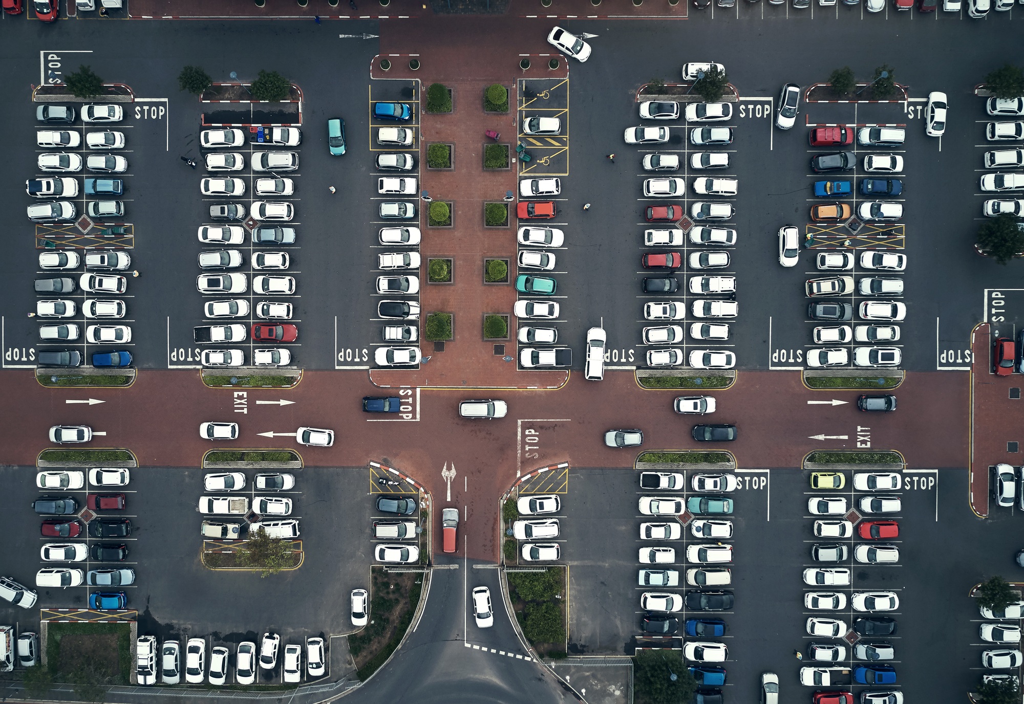 Parking lots are filling up again. High angle shot of a large parking lot in an urban city.