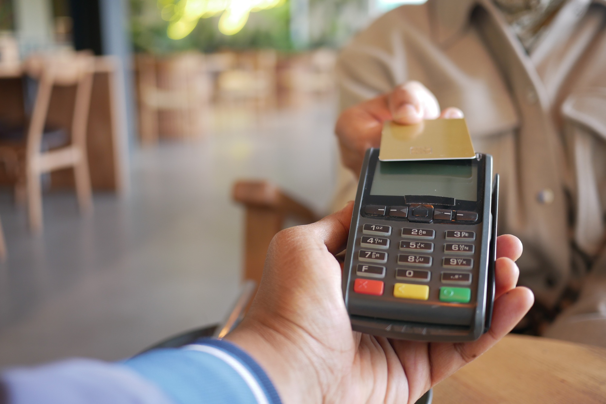 Payment process in a modern cafe during the afternoon