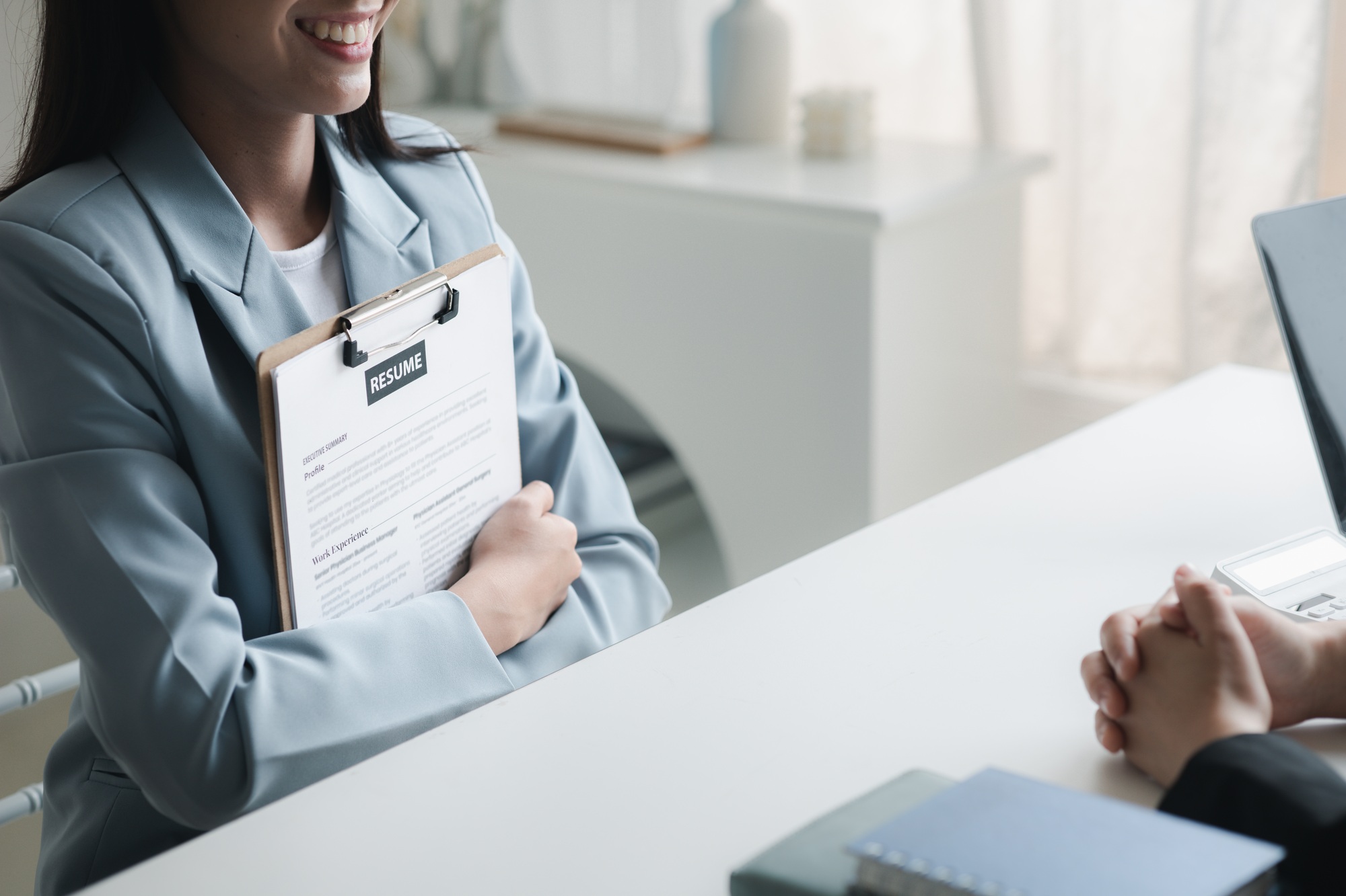 Person submitting resume to interview for a job with a company, Person attending a job interview wit