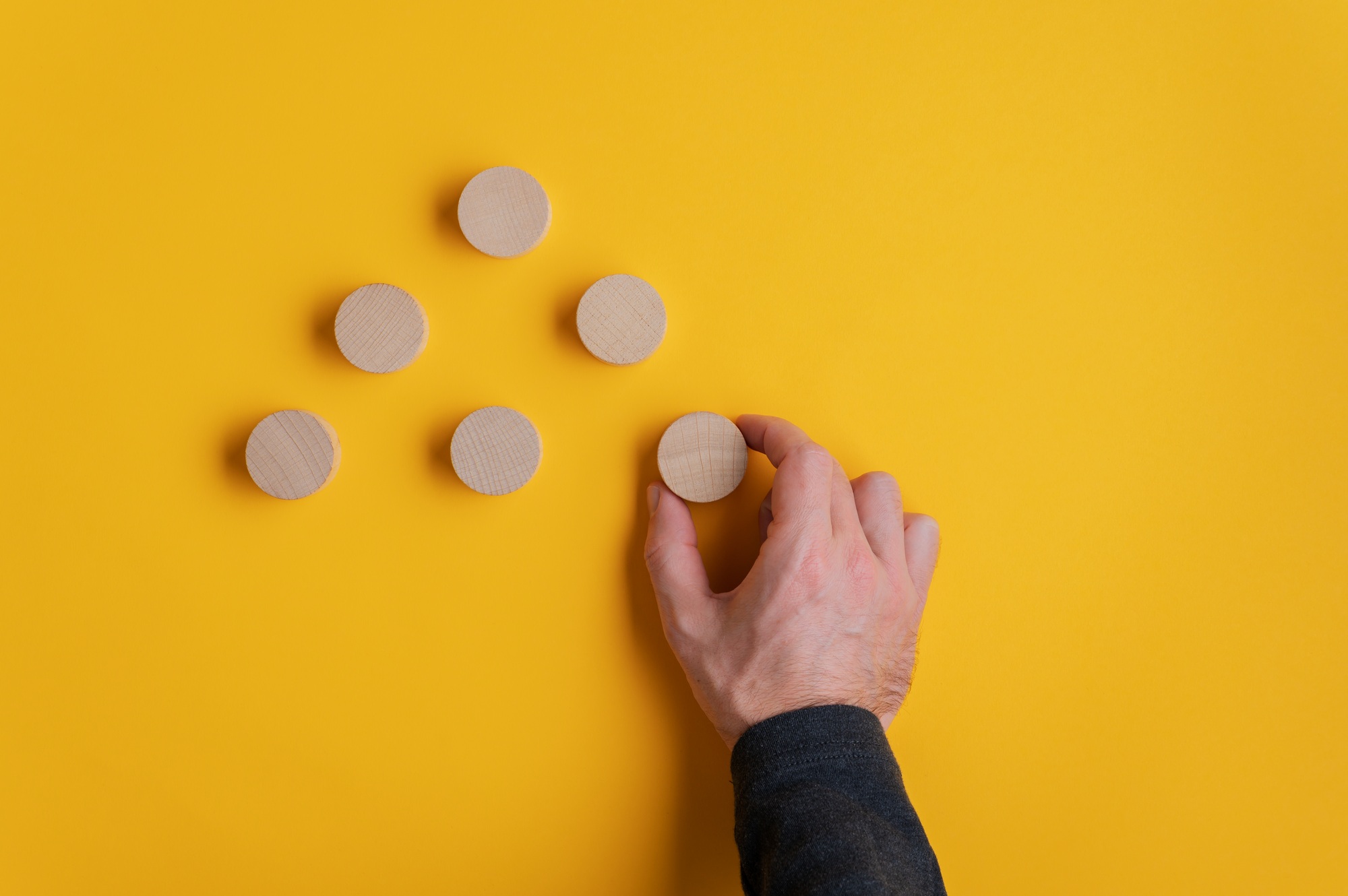 Placing blank wooden cut circles in a pyramid shape
