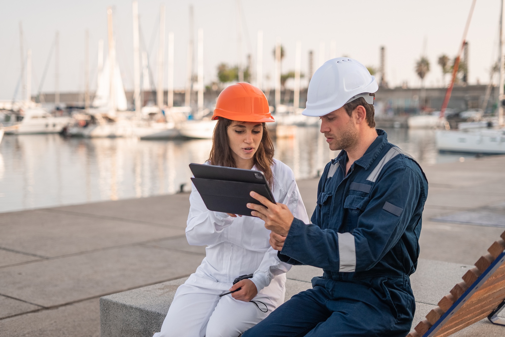 Port managers with tablet discussing project