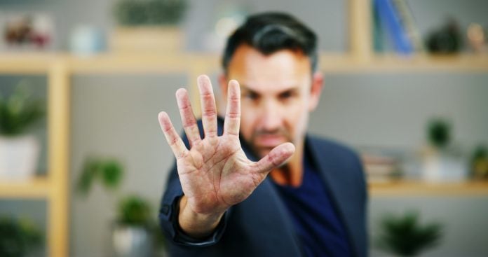 Portrait, business and man with stop hand, warning and fraud prevention in modern office. Face, emp