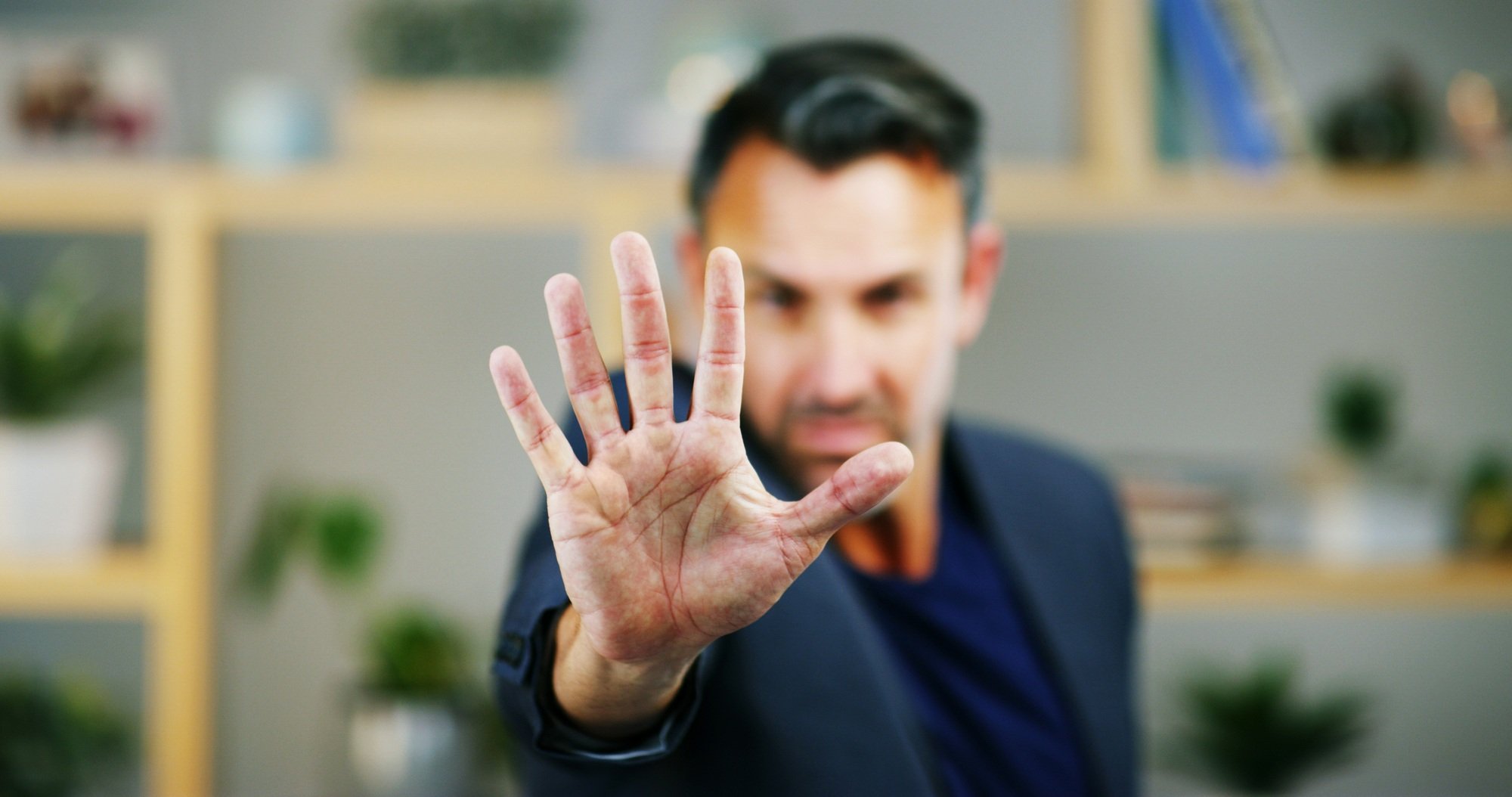 Portrait, business and man with stop hand, warning and fraud prevention in modern office. Face, emp