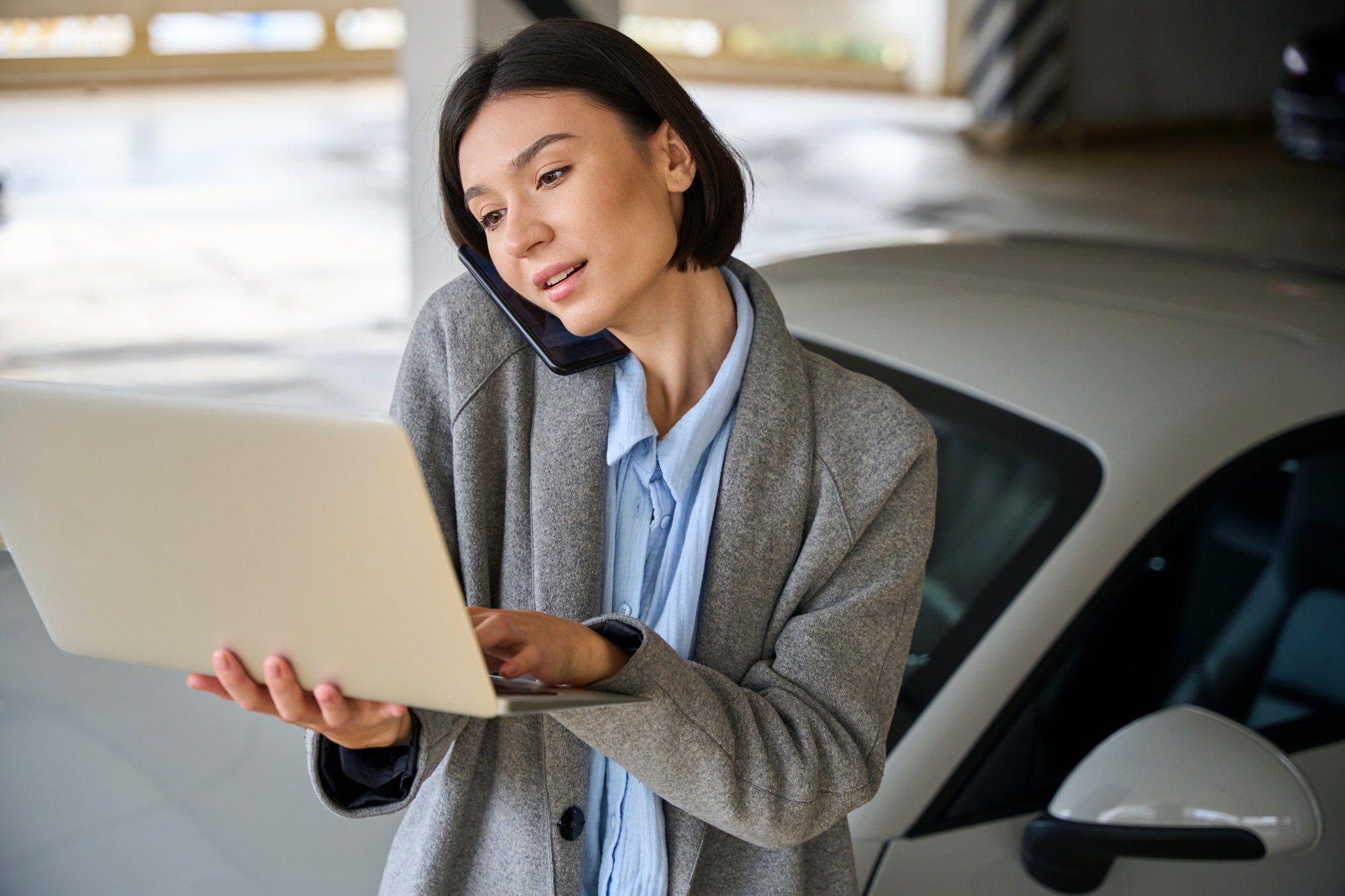 Pretty female solve business tasks from parking