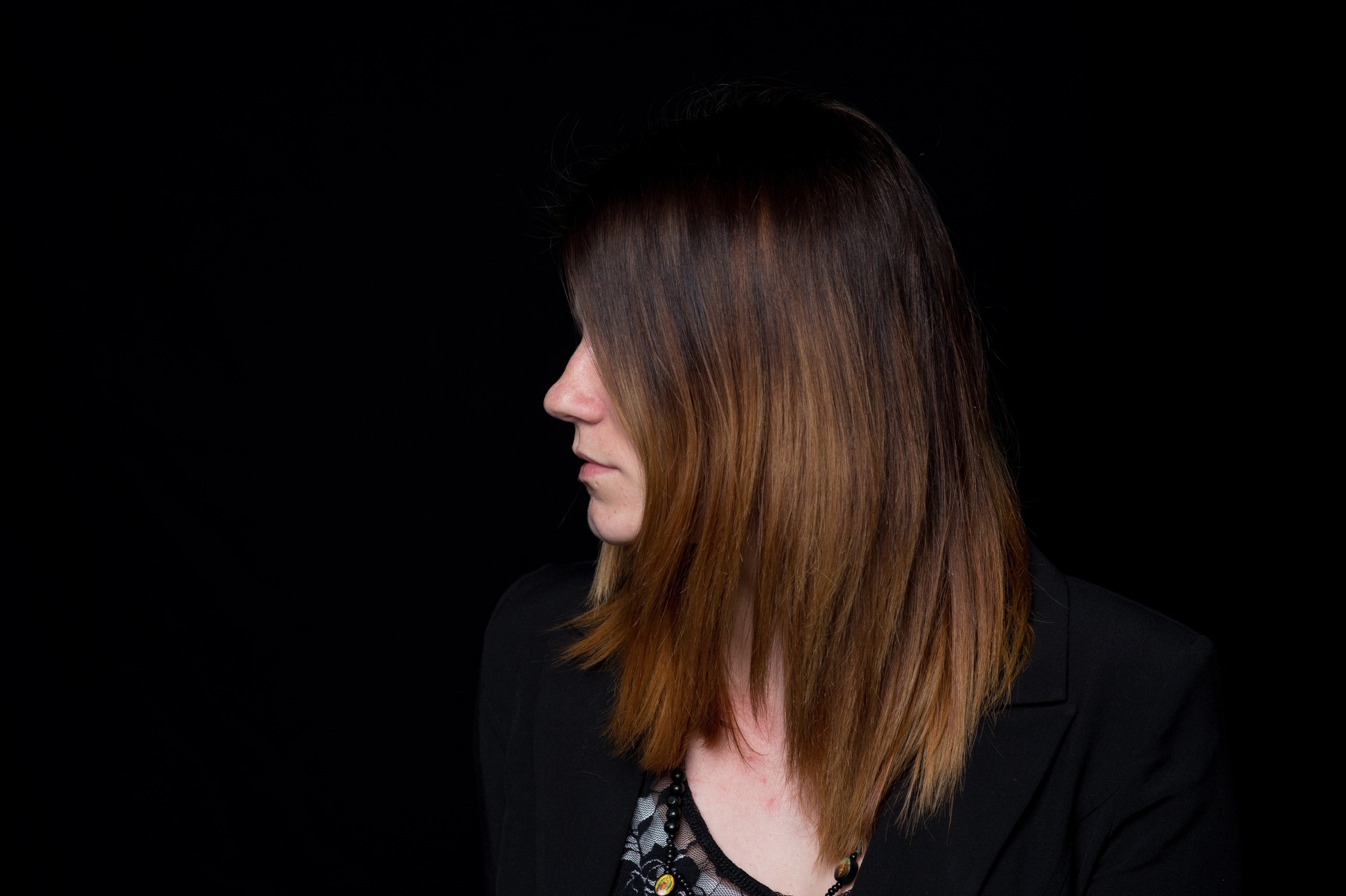 Profile of young woman with ombré hair wearing a blazer.