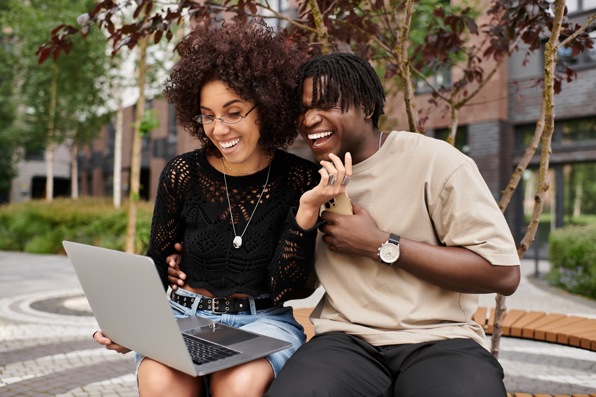 Remote work joy for an african american couple in a vibrant city setting
