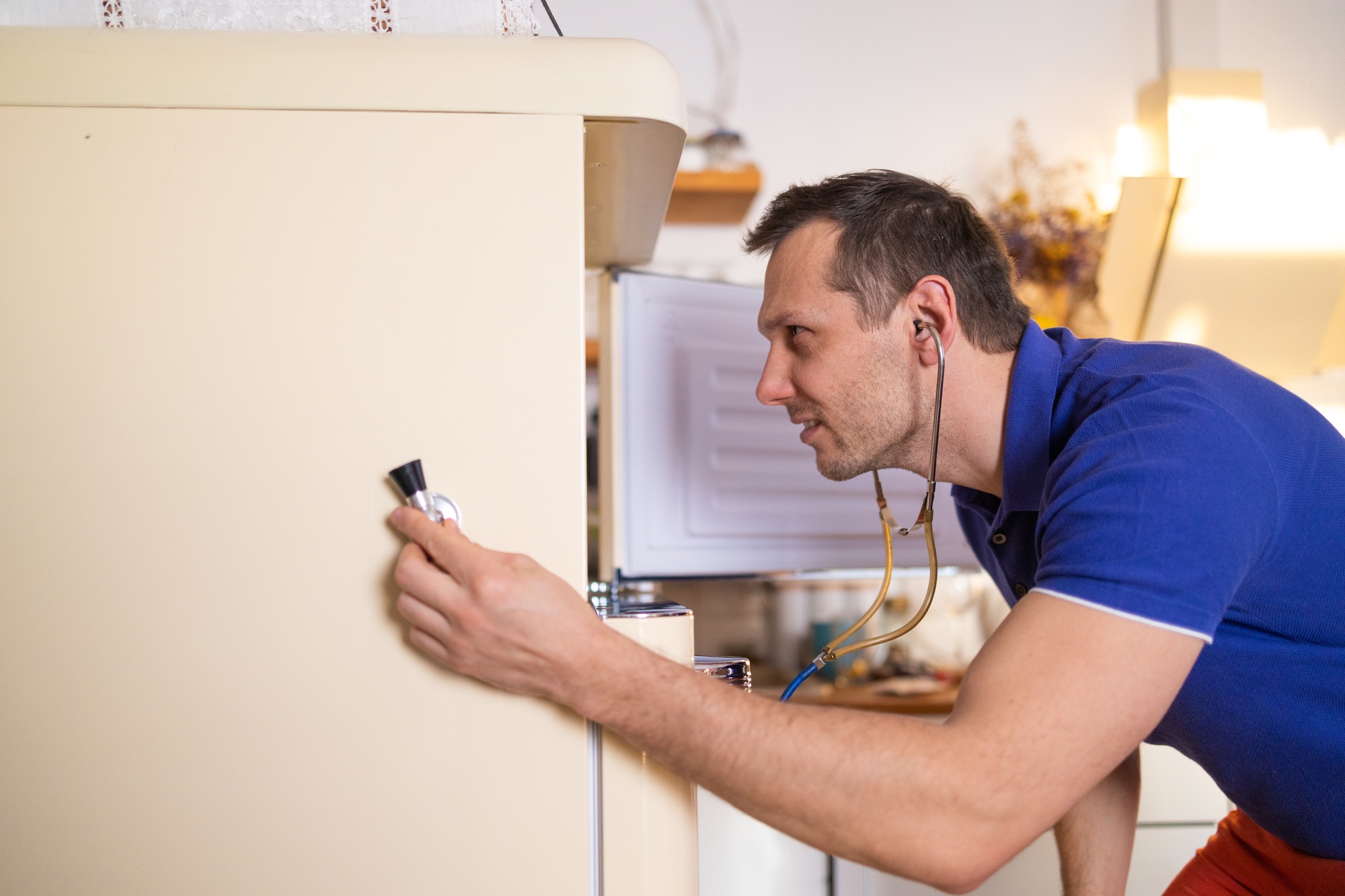 Repairman contractor repairing fridge in DIY concept