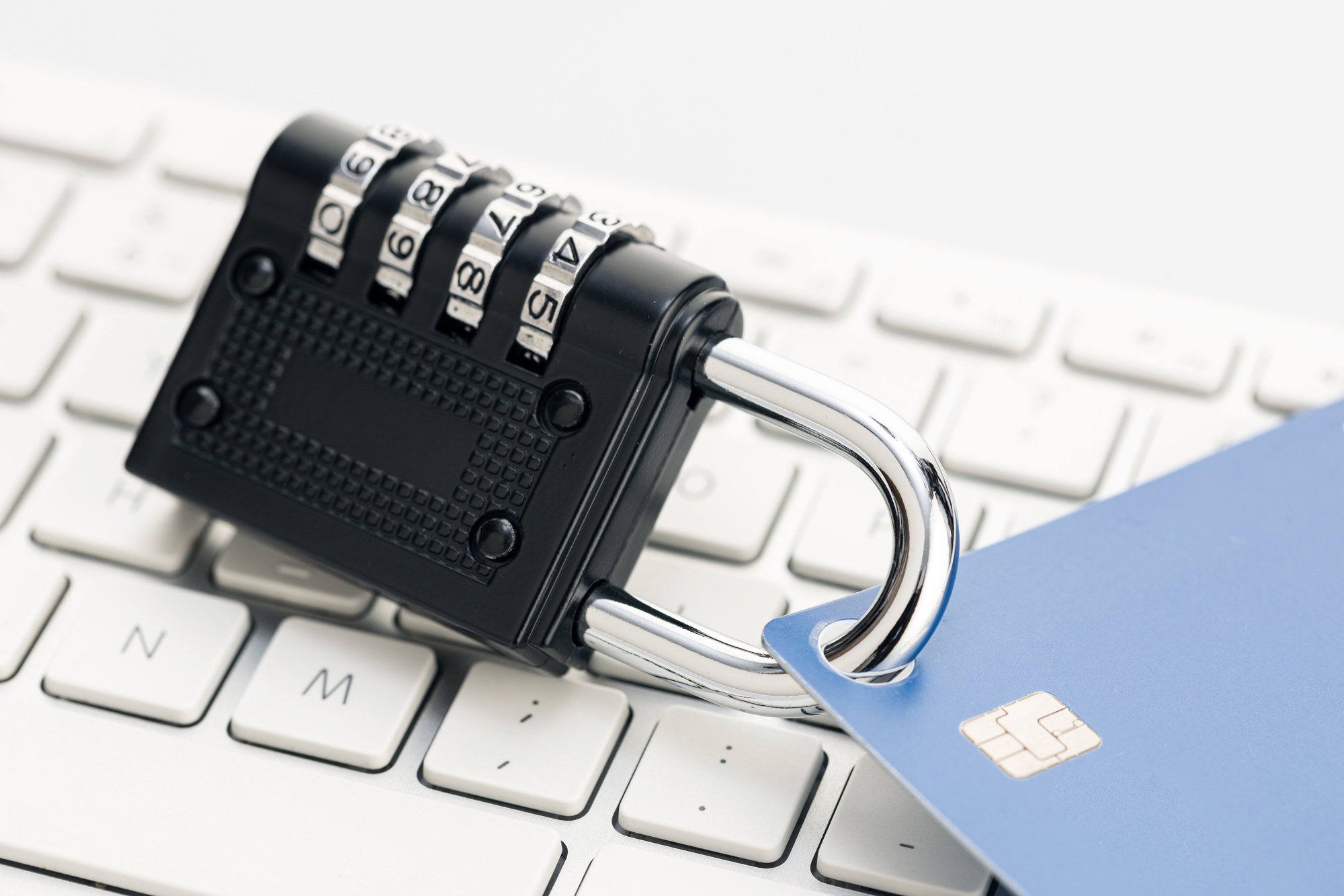 Security lock closed on credit card on computer keyboard