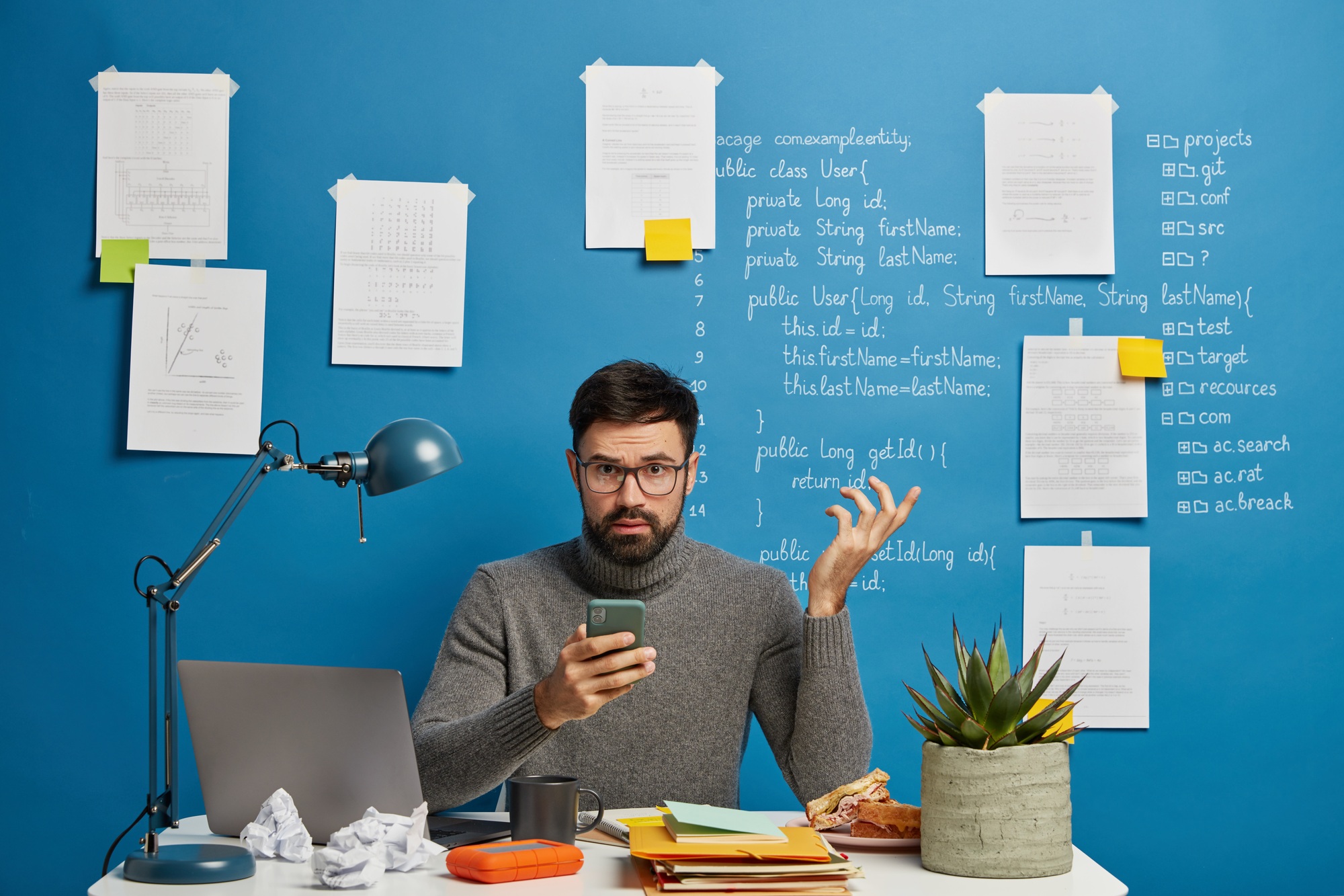 Skilled male programmer or IT project manager tries solve problem with modern technologies, keeps ha