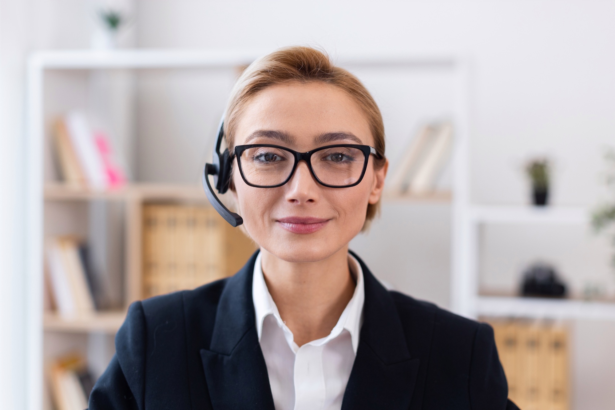 Smiling customer service representative using headset in office environment