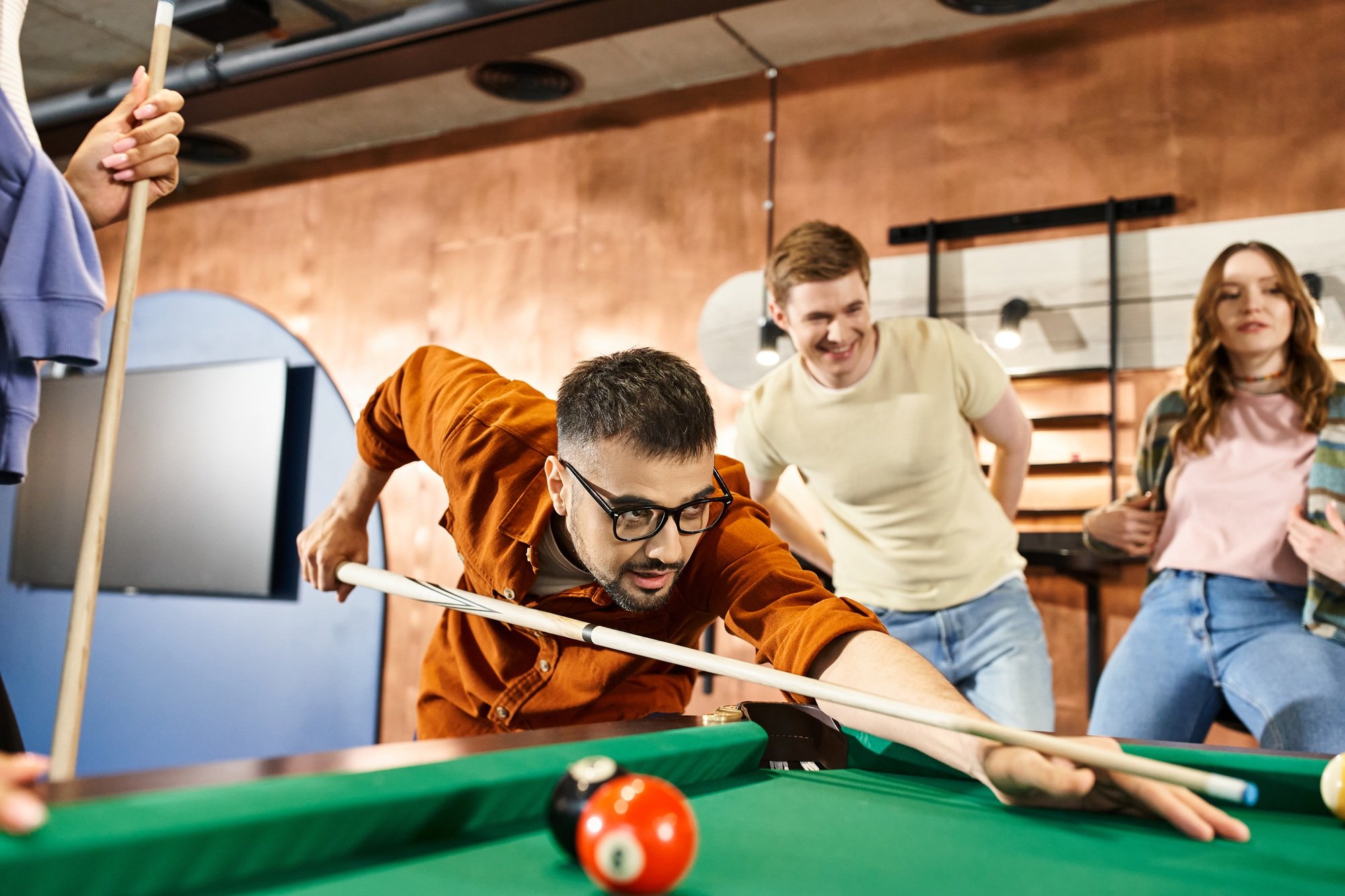 Strategic shots: a group of colleagues playing pool in a modern coworking space