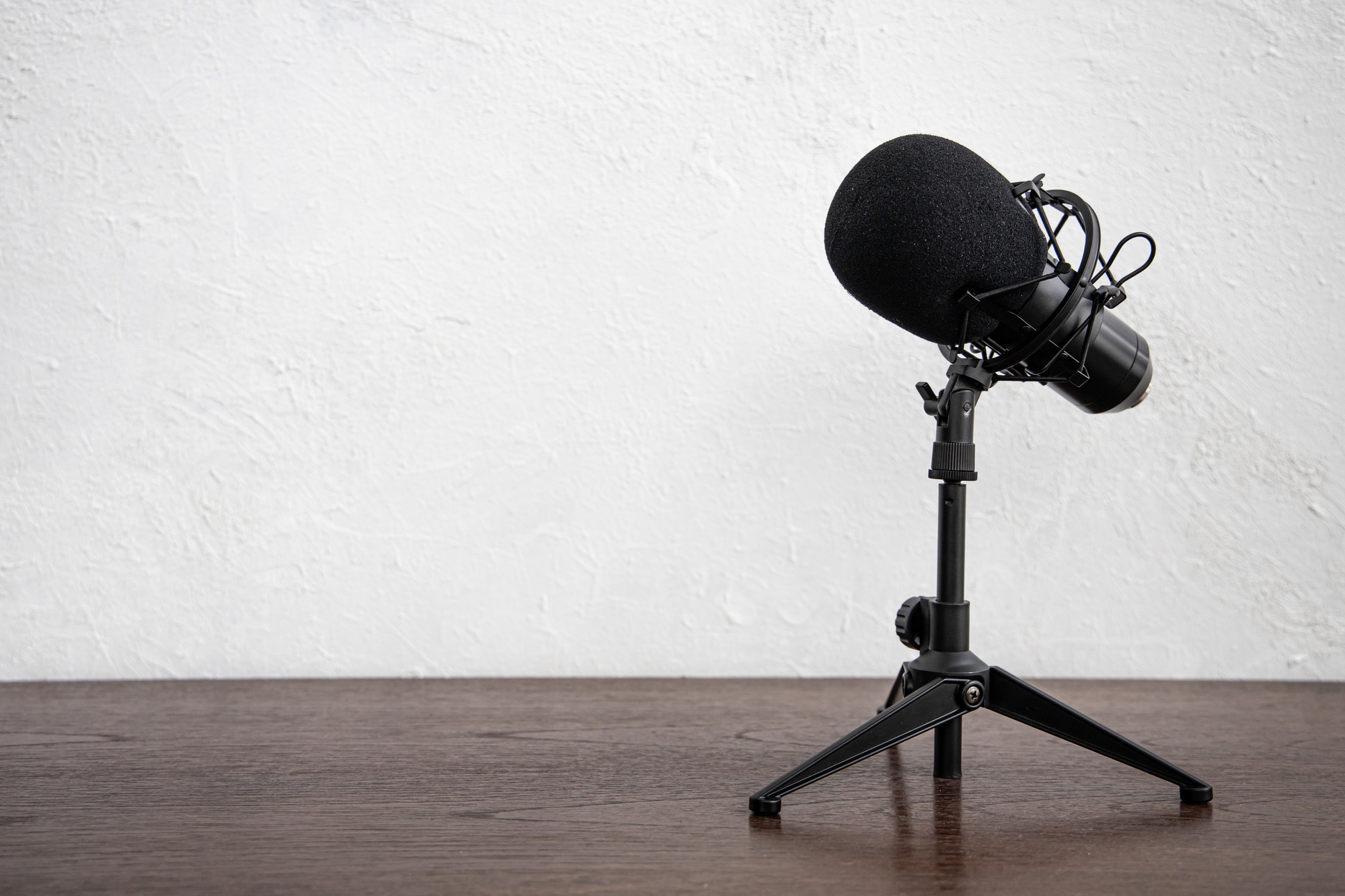 Studio Condenser Microphone for home studio radio podcast on white room wood table background