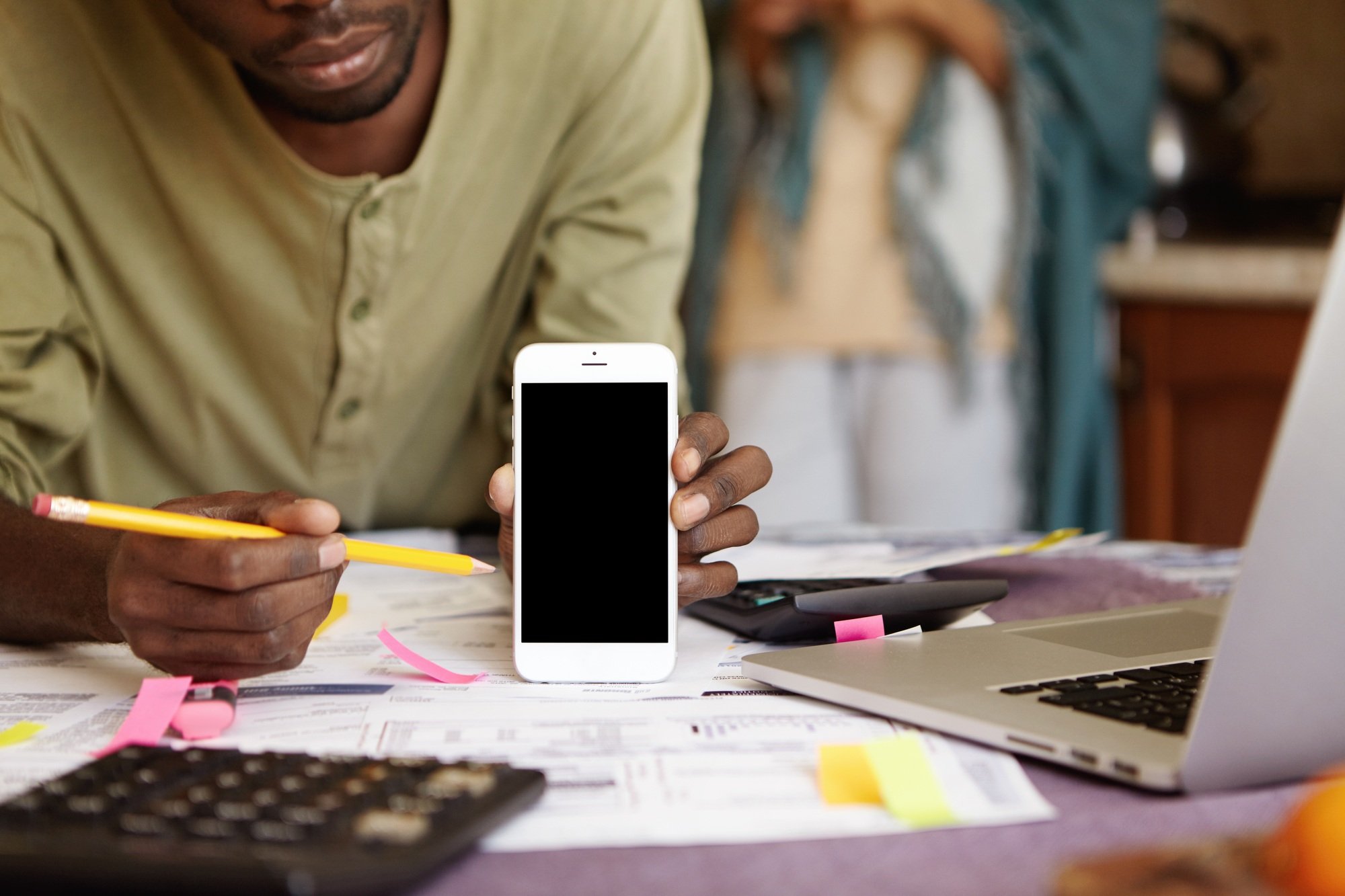 Technology and advertising concept. Cropped shot of African-American man holding mobile phone and po
