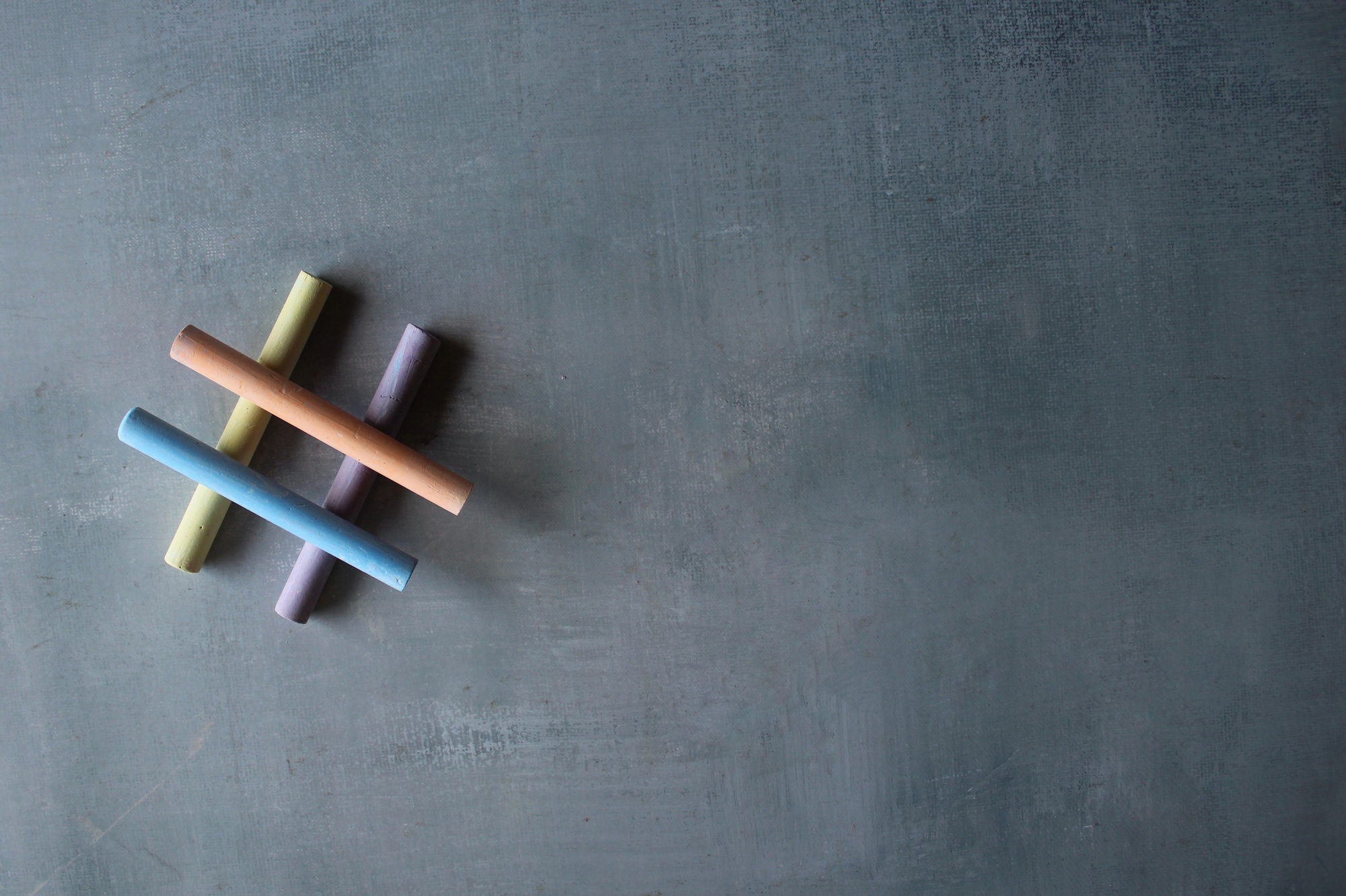 Top view image of colorful chalk and hashtag icon