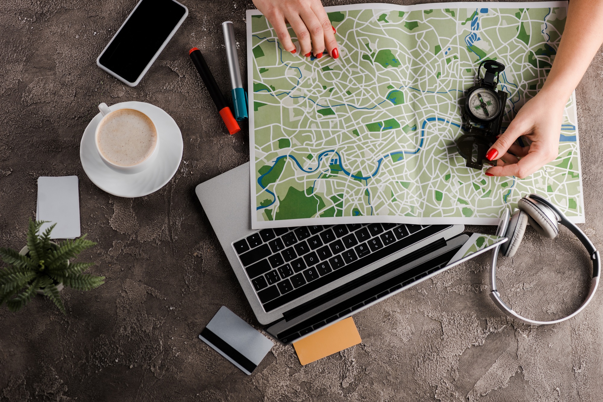 top view of woman near map, compass, credit cards and gadgets, e-commerce concept, e-commerce