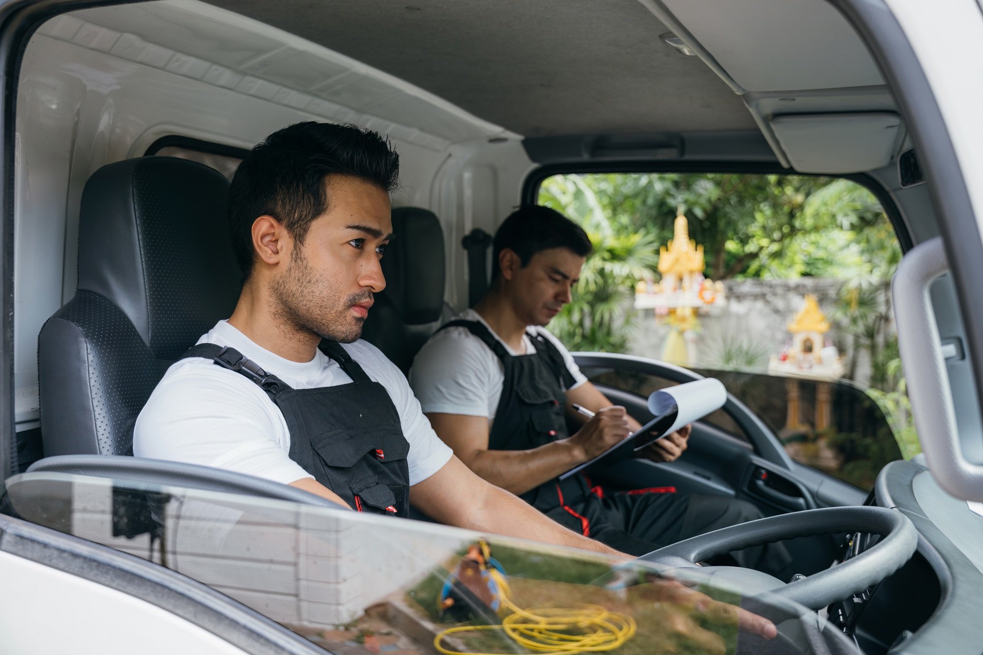 Truck driver and mover workers for relocation service. Ethnic diversity in the team delivering and