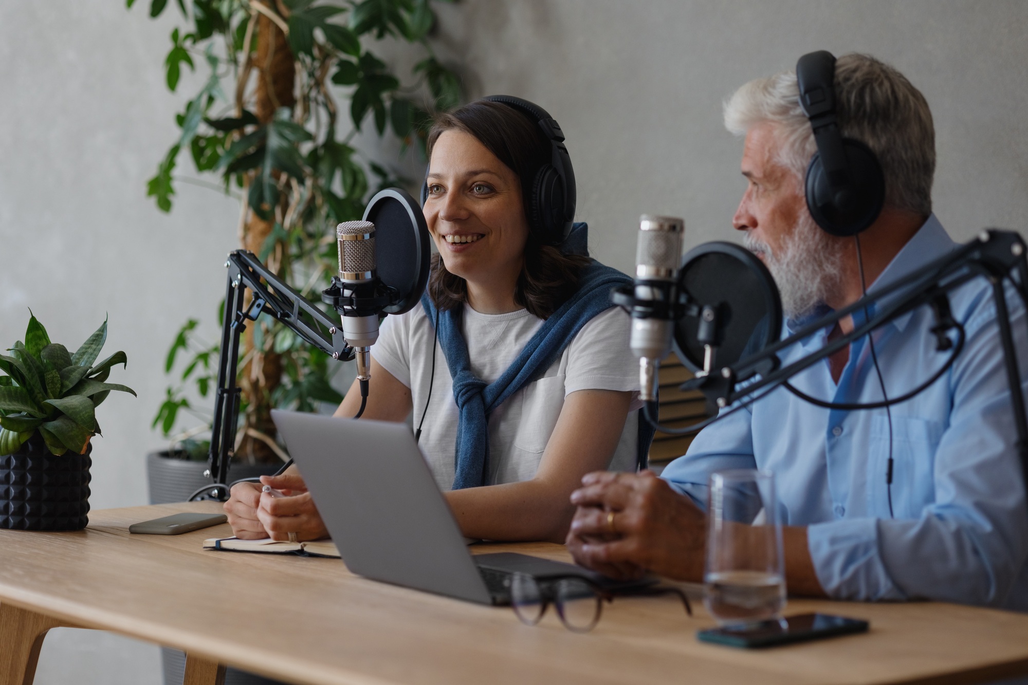 two people man and woman recording an interview or program on the radio