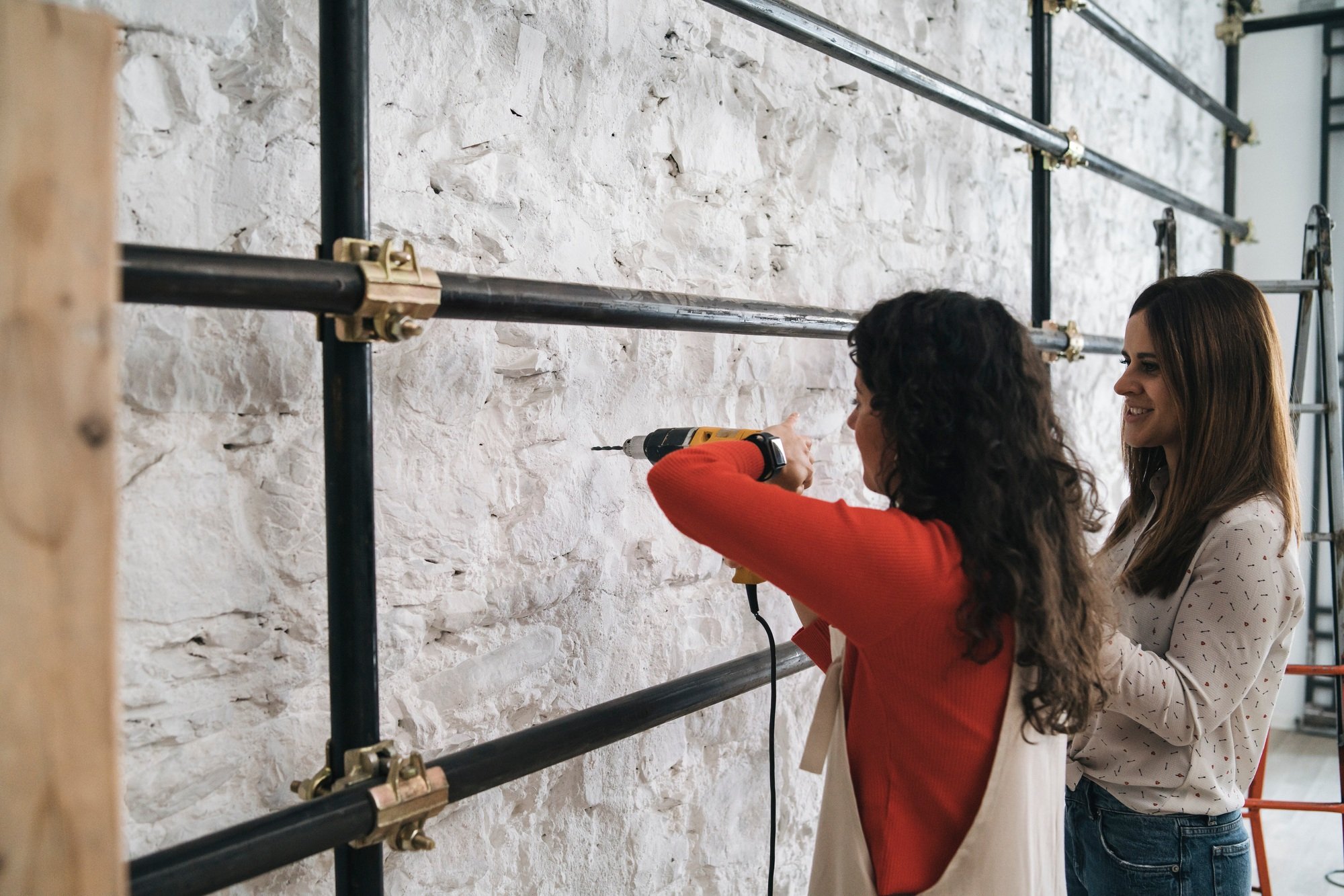 Two women enjoying a DIY project.