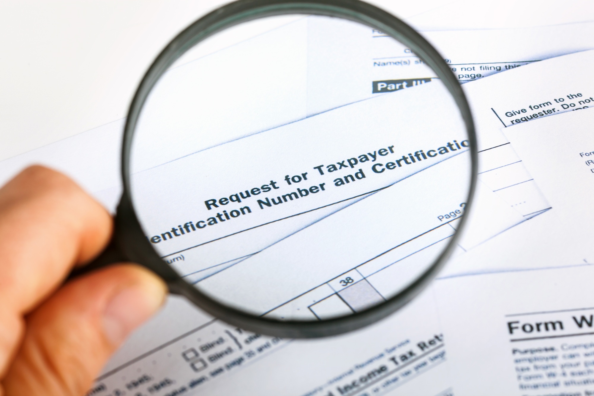 US Individual Tax Return Form 1040 close up with magnifying glass