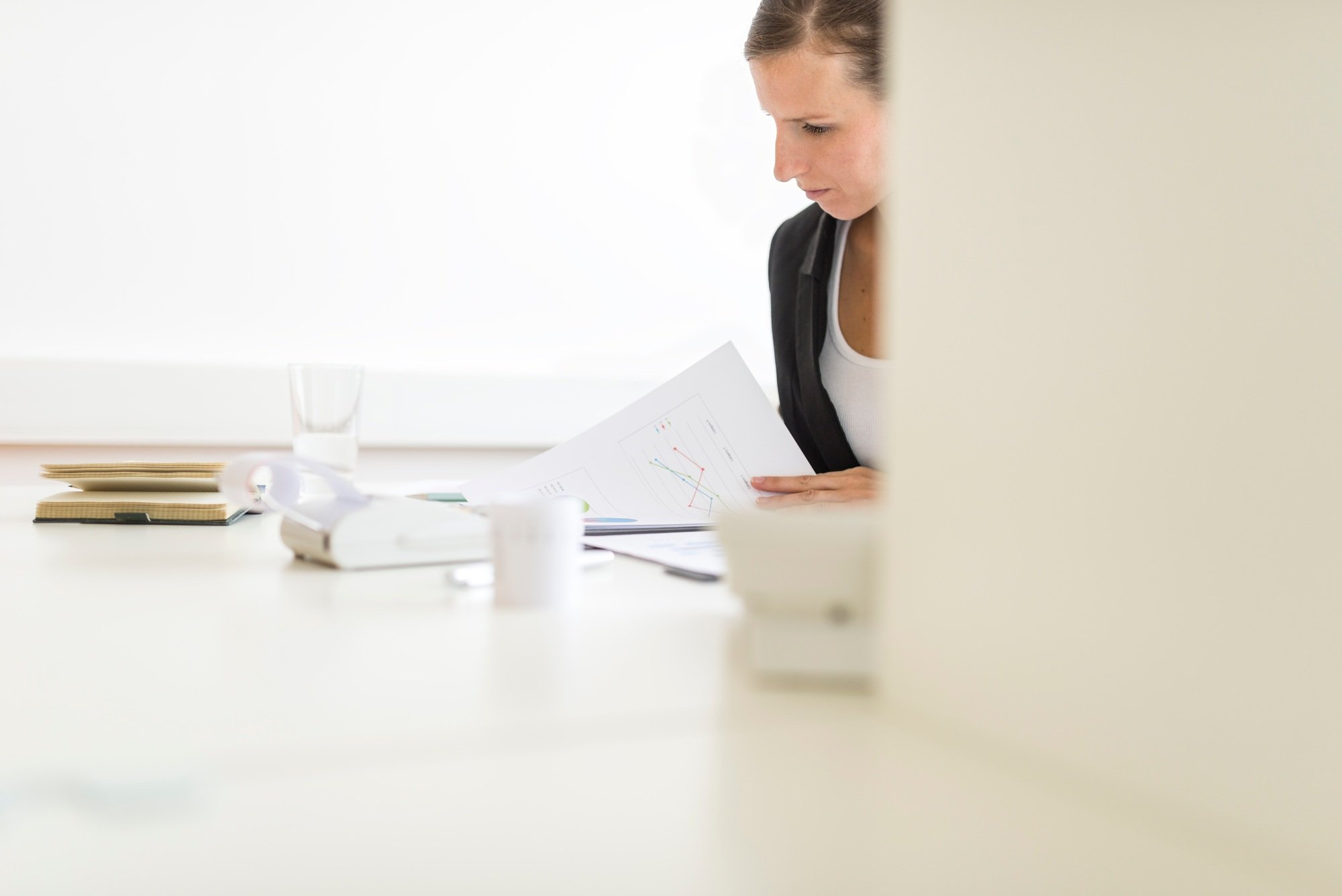 View around a partition of a woman in an office
