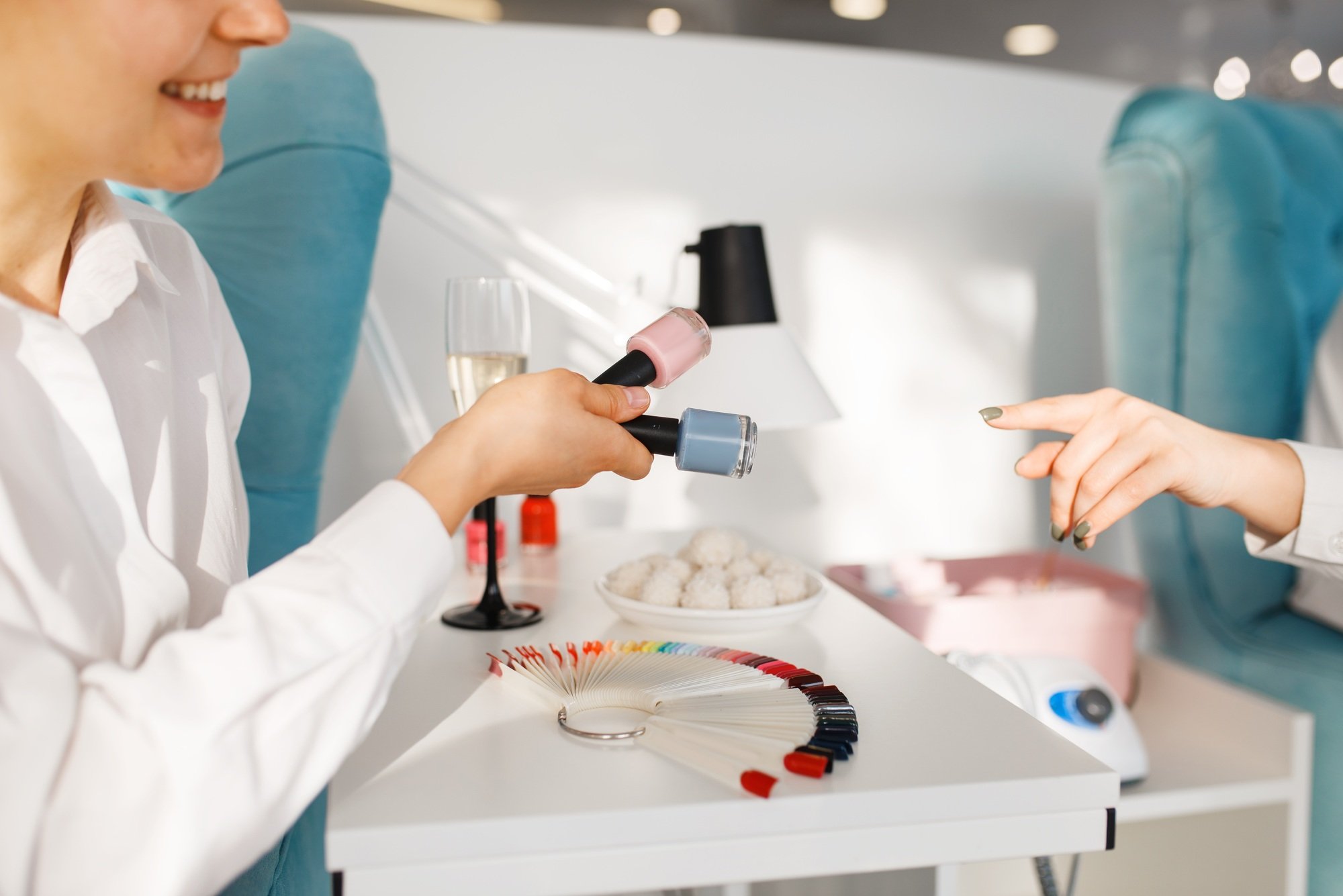 Woman choosing nail varnish in beauty salon