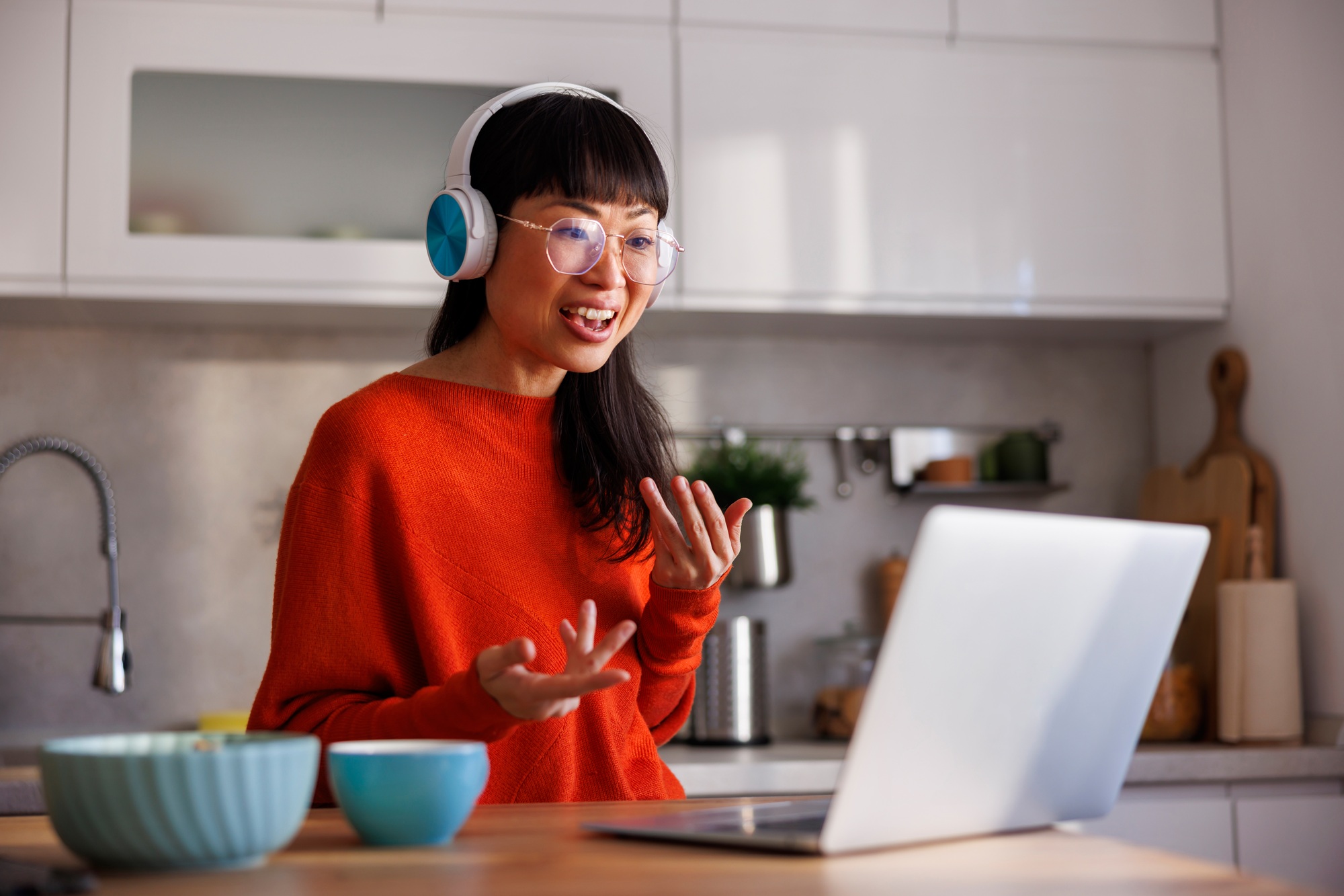 Woman having conference call while working remotely from