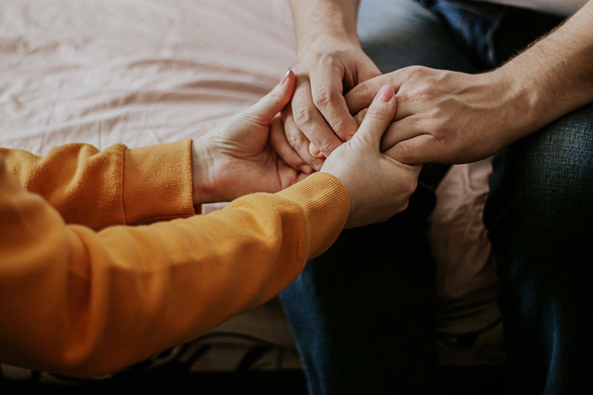 Woman holds the hands of elderly father. Help and support, act of caring and kindness.