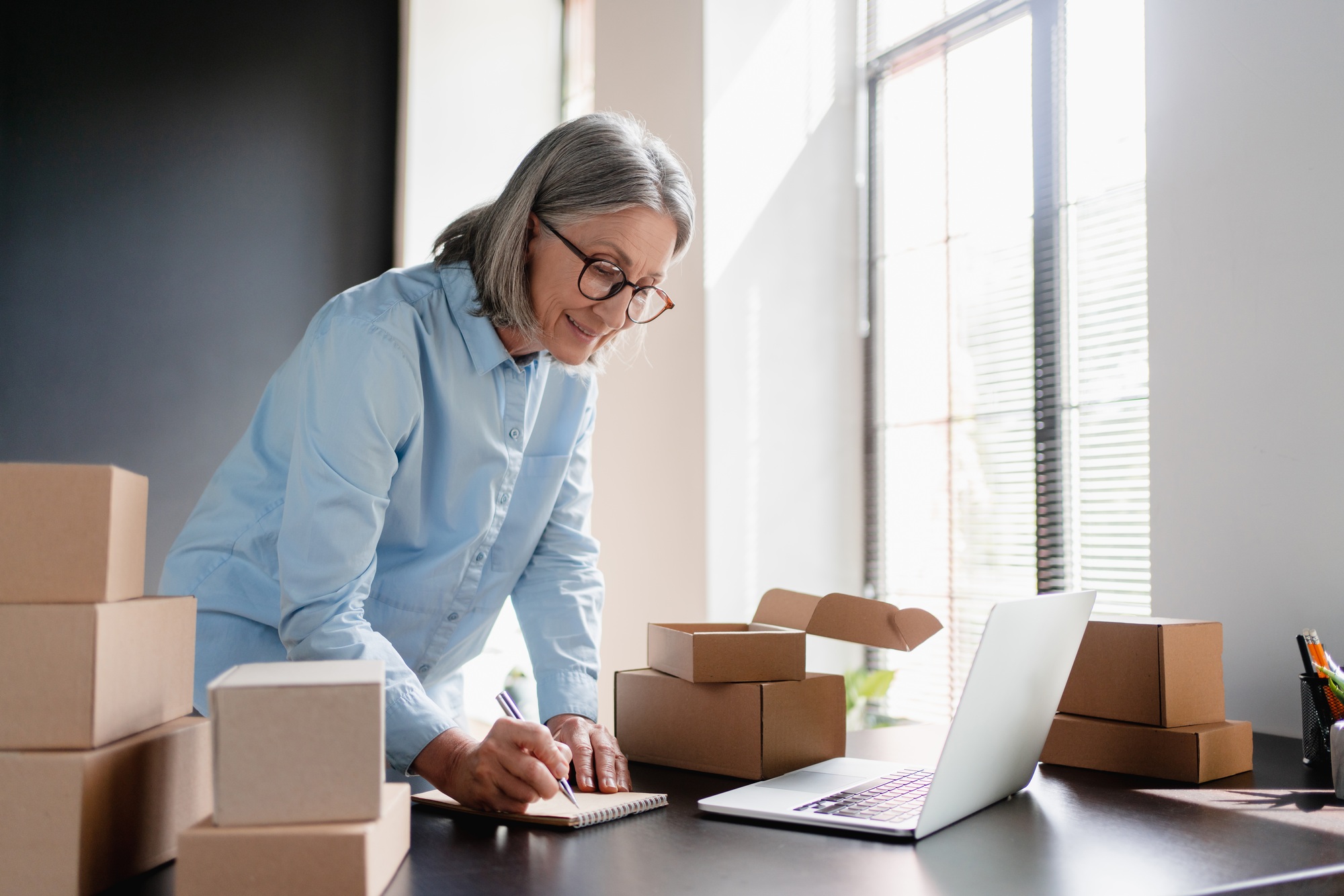 Woman, laptop and checklist for small business, ecommerce and boutique startup with online sales.