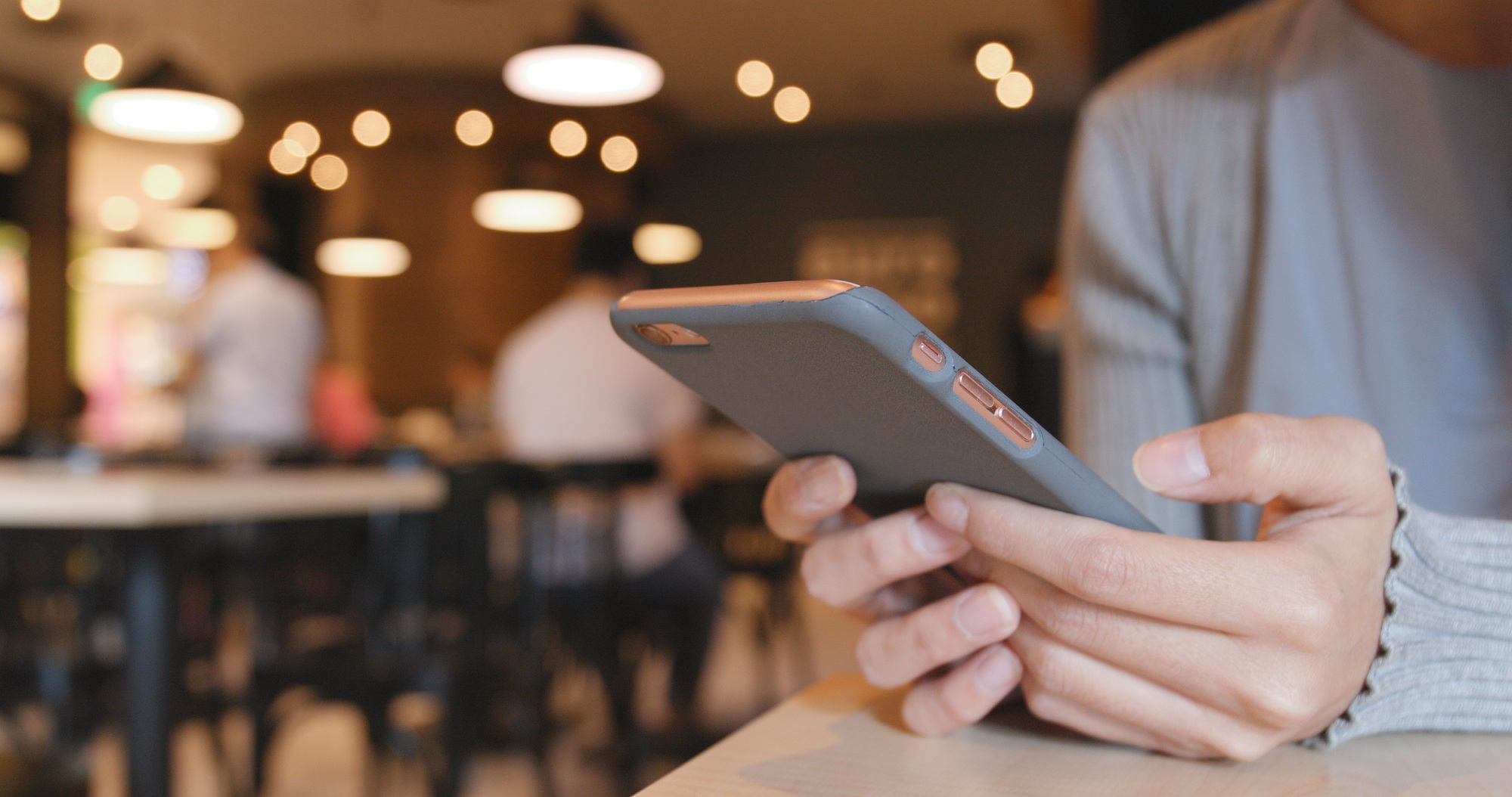 Woman use of mobile phone in restaurant