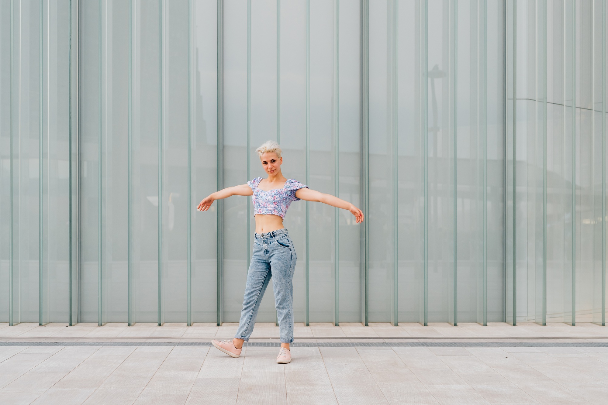 Young caucasian woman outdoor dancing celebrating success feeling free - advertising copyspace