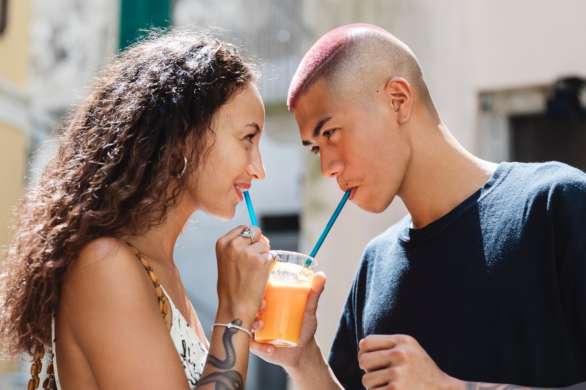 Young couple drinking fruit juice together