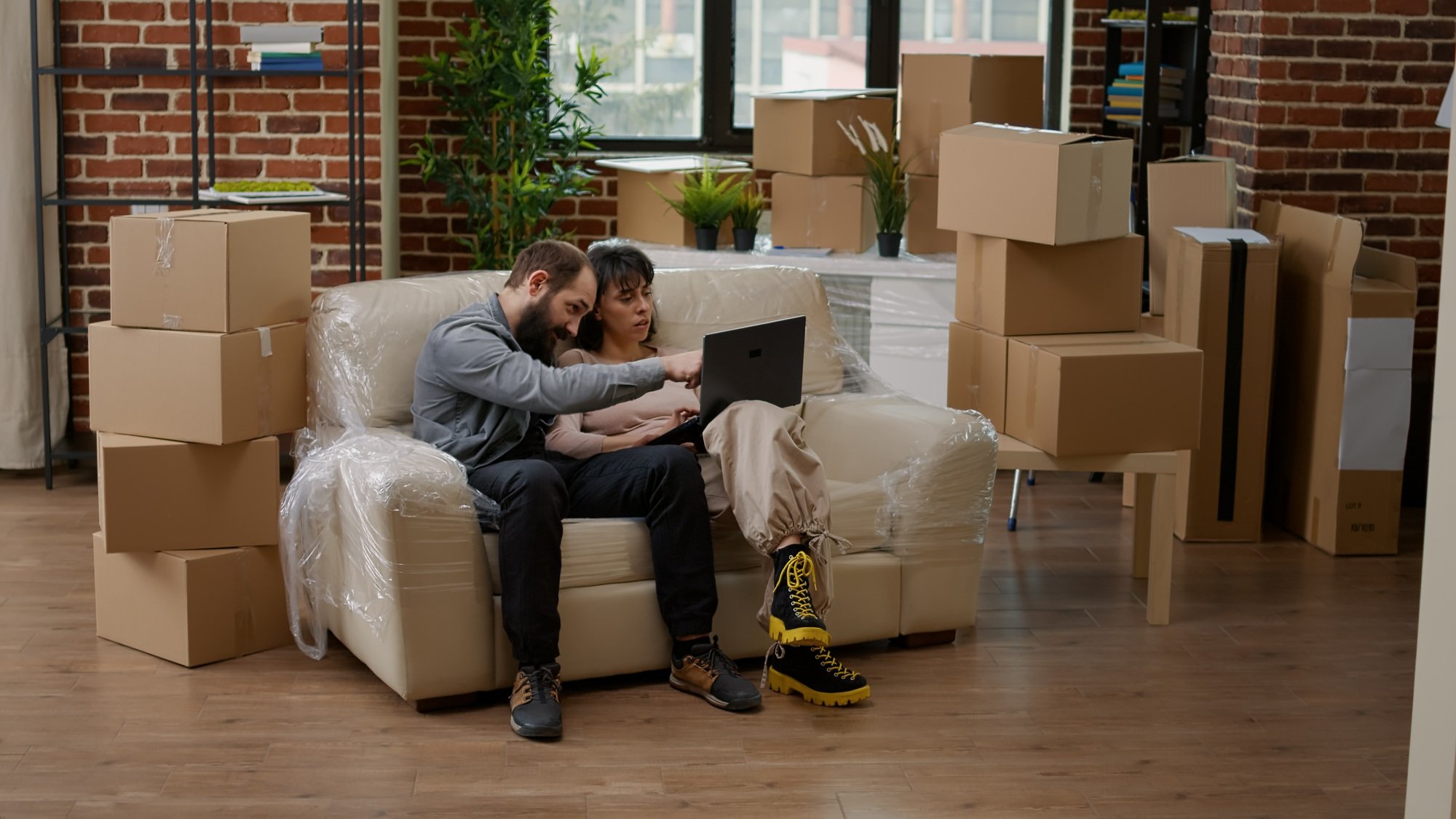 Young couple looking at interior decor on laptop website