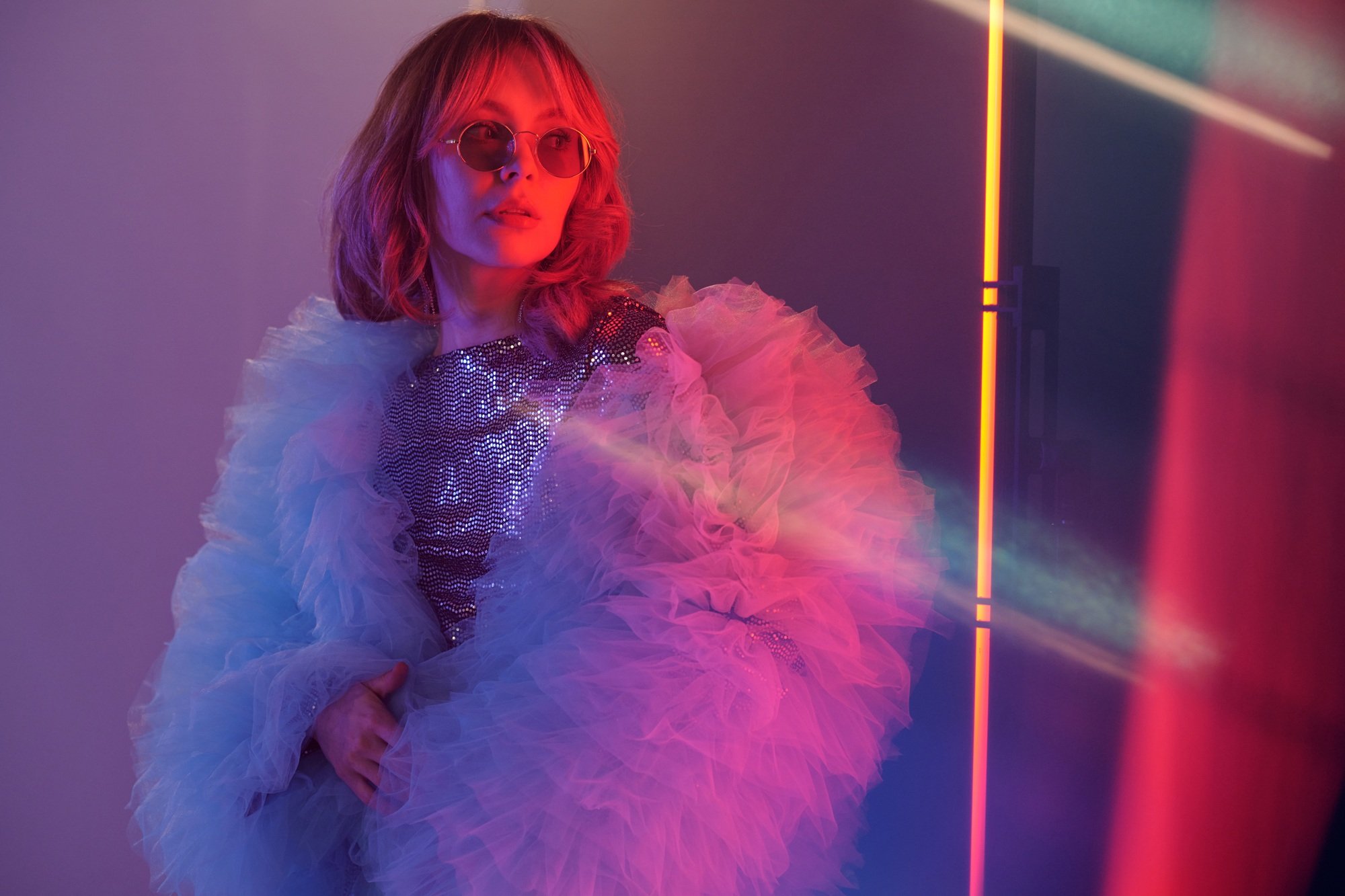 Young Woman Posing In Dramatic Lighting Setup For Video Shoot