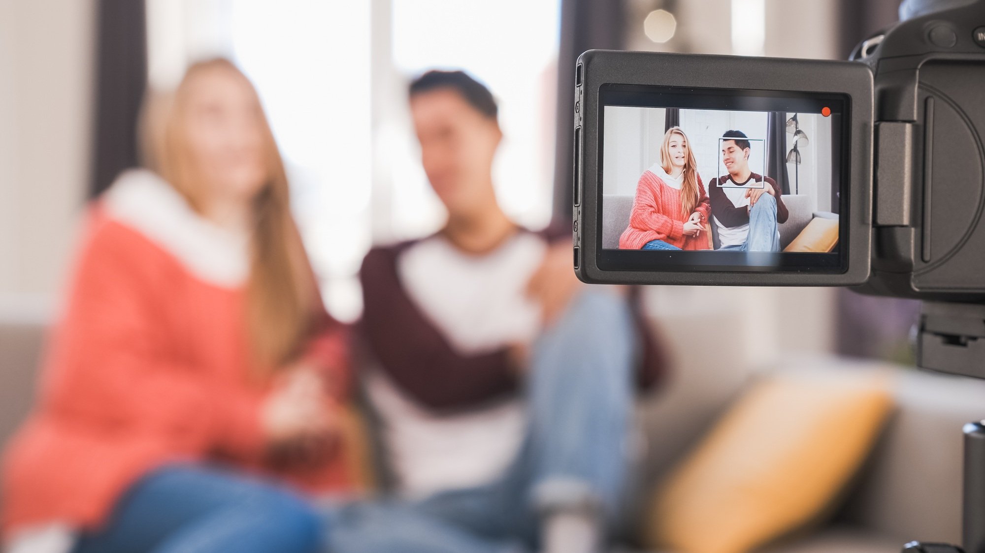 Young youtubers or bloggers creating content for social media while making a video at home.